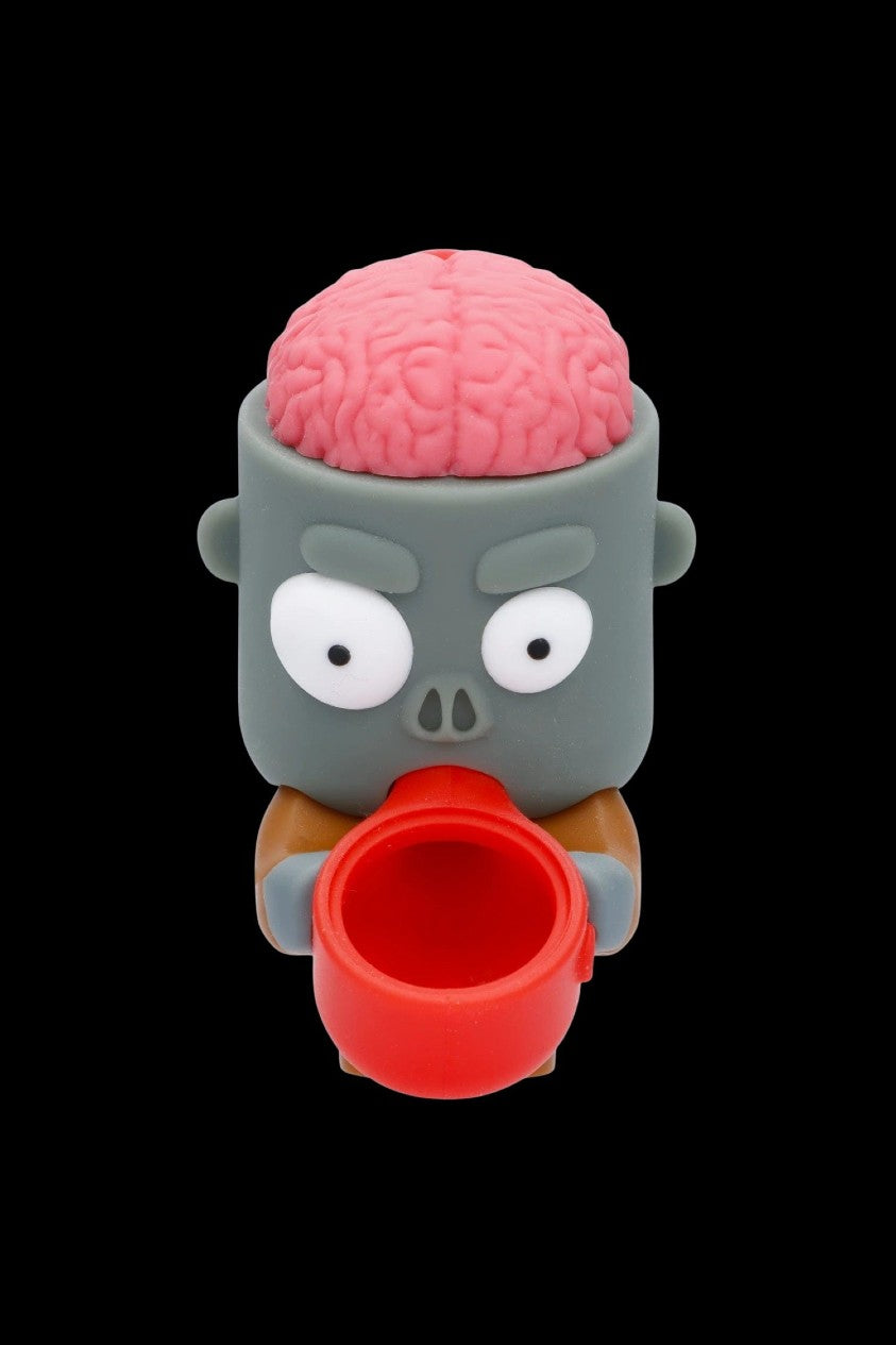 A silicone smoking piece shaped like a zombie head with a visible brain and a red bowl.