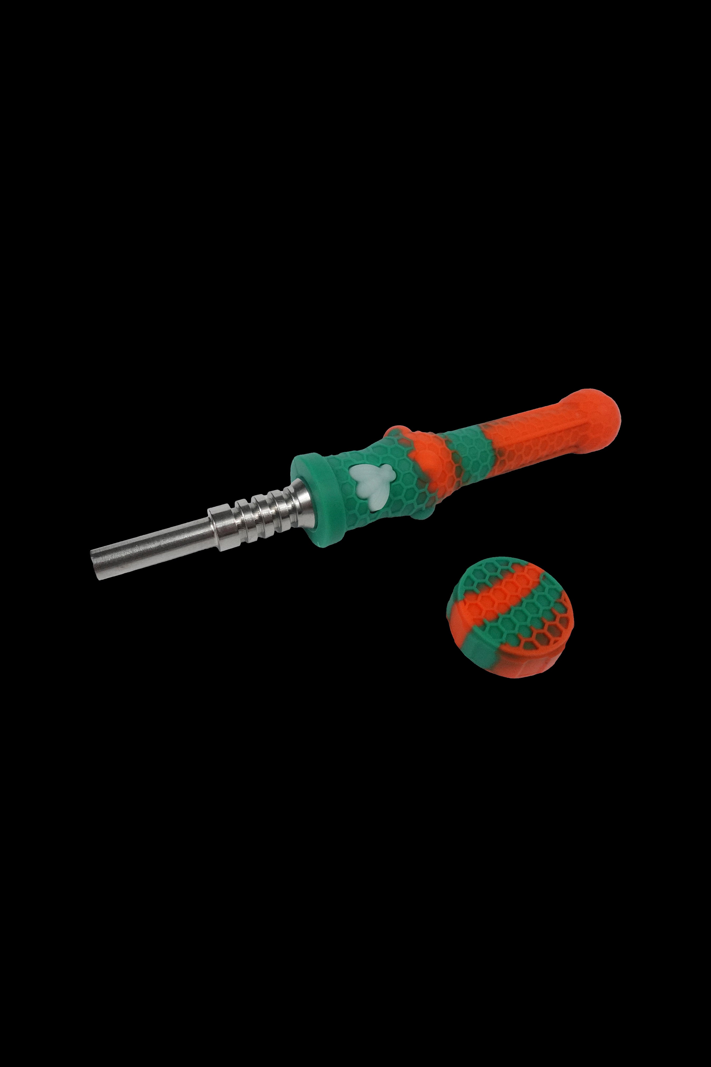 Green and red silicone dab tool with metal tip and cap on a black background.