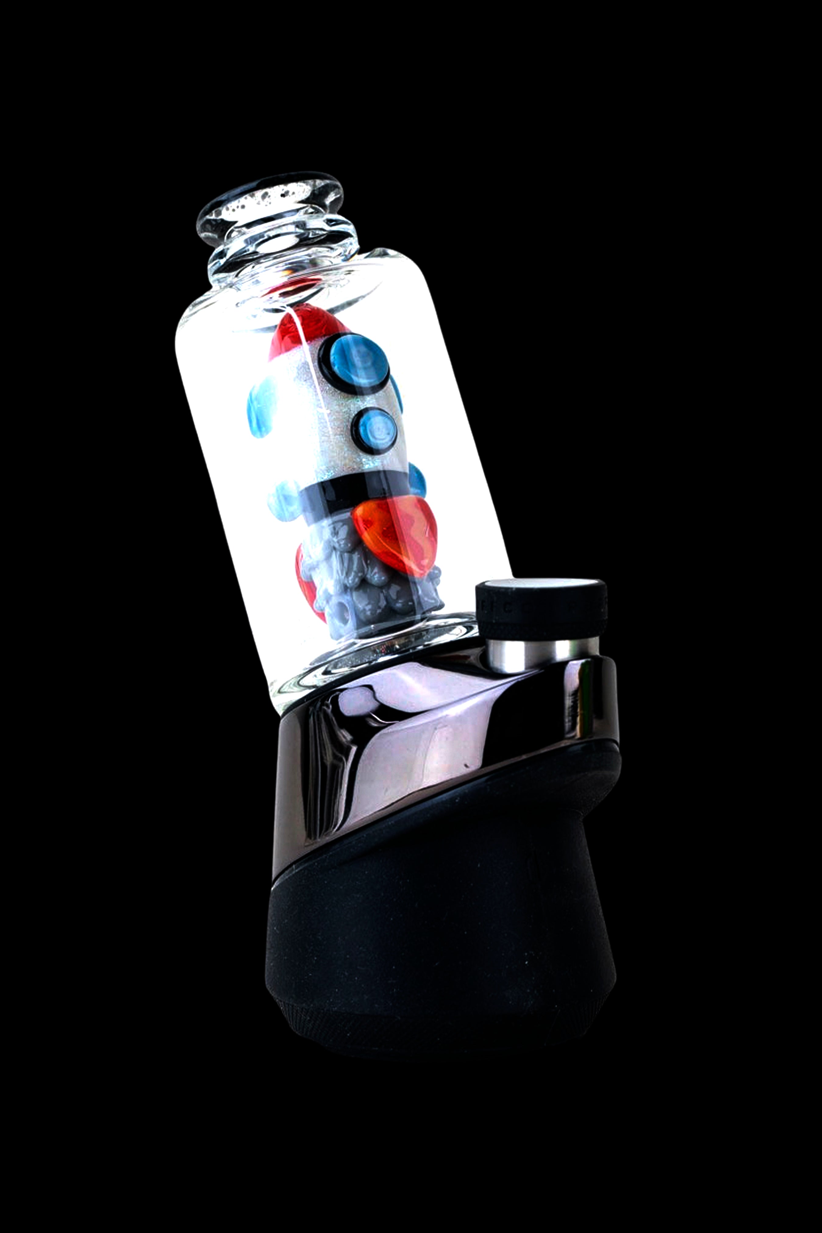 A black and glass cannabis vaporizer with colorful oil visible inside the glass chamber, set against a black background.