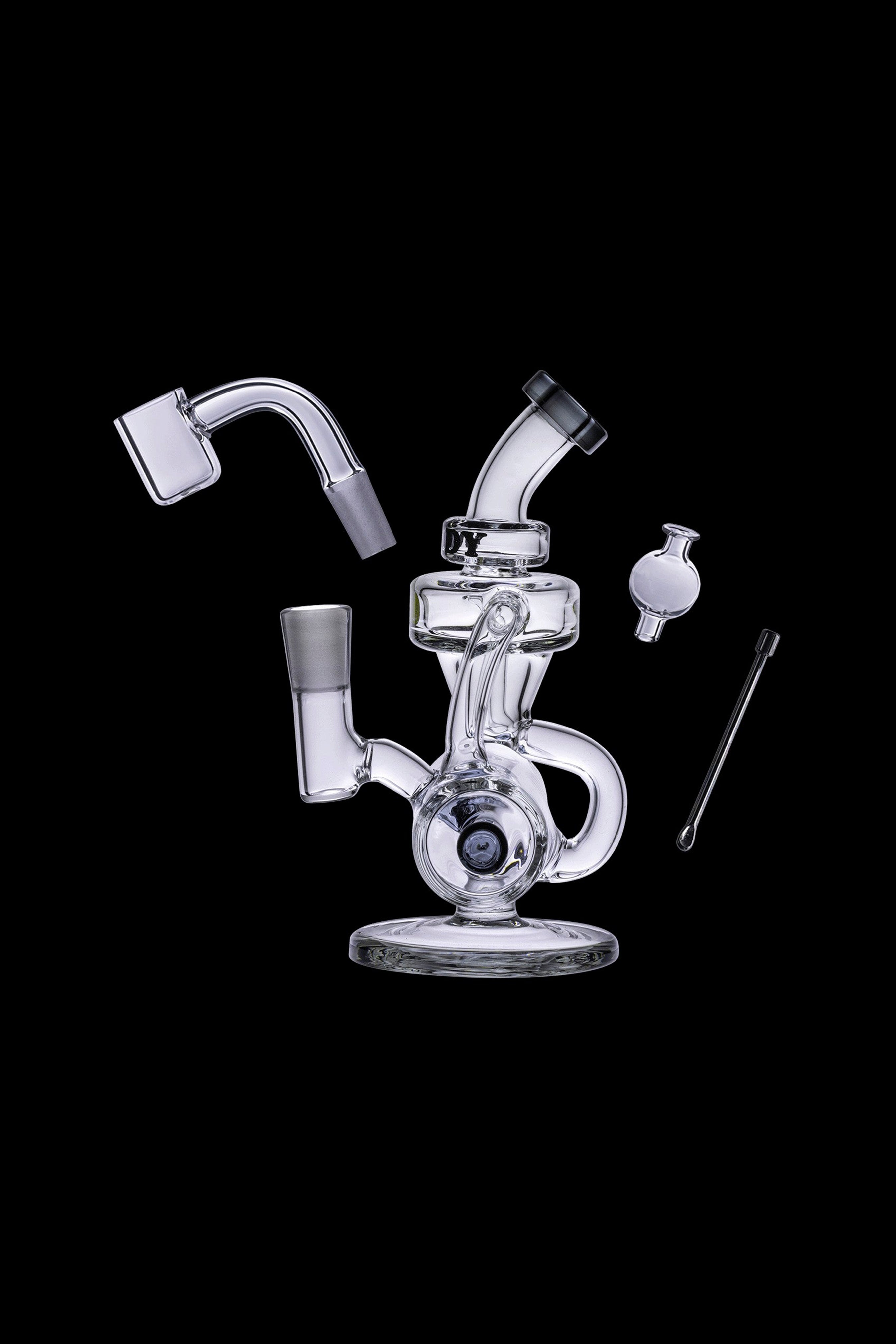 Clear glass dab rig with separate components including a banger, carb cap, and tool, isolated on a black background.