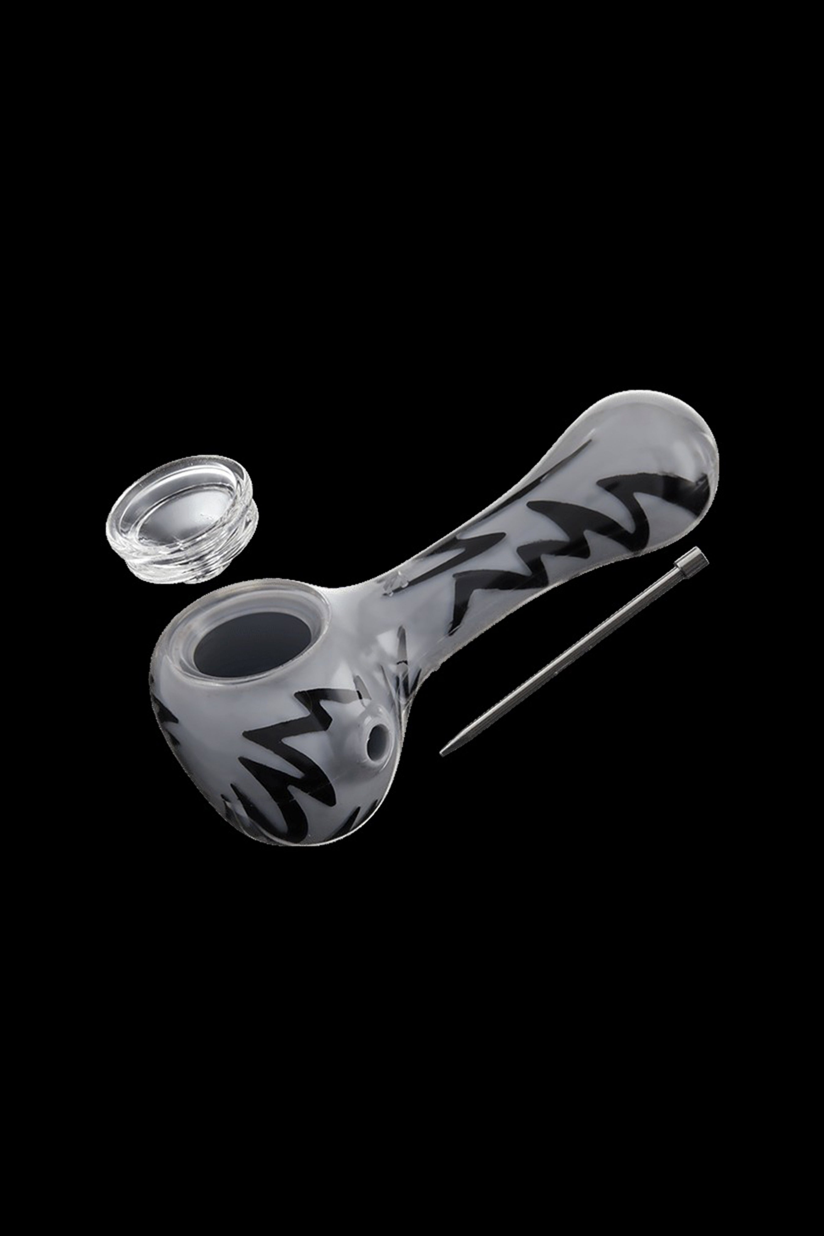 Glass pipe with abstract black swirl design, alongside a small clear container and metal tool, against a black background.