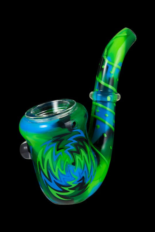 Green and blue glass bubbler pipe with swirling patterns, isolated on a black background.