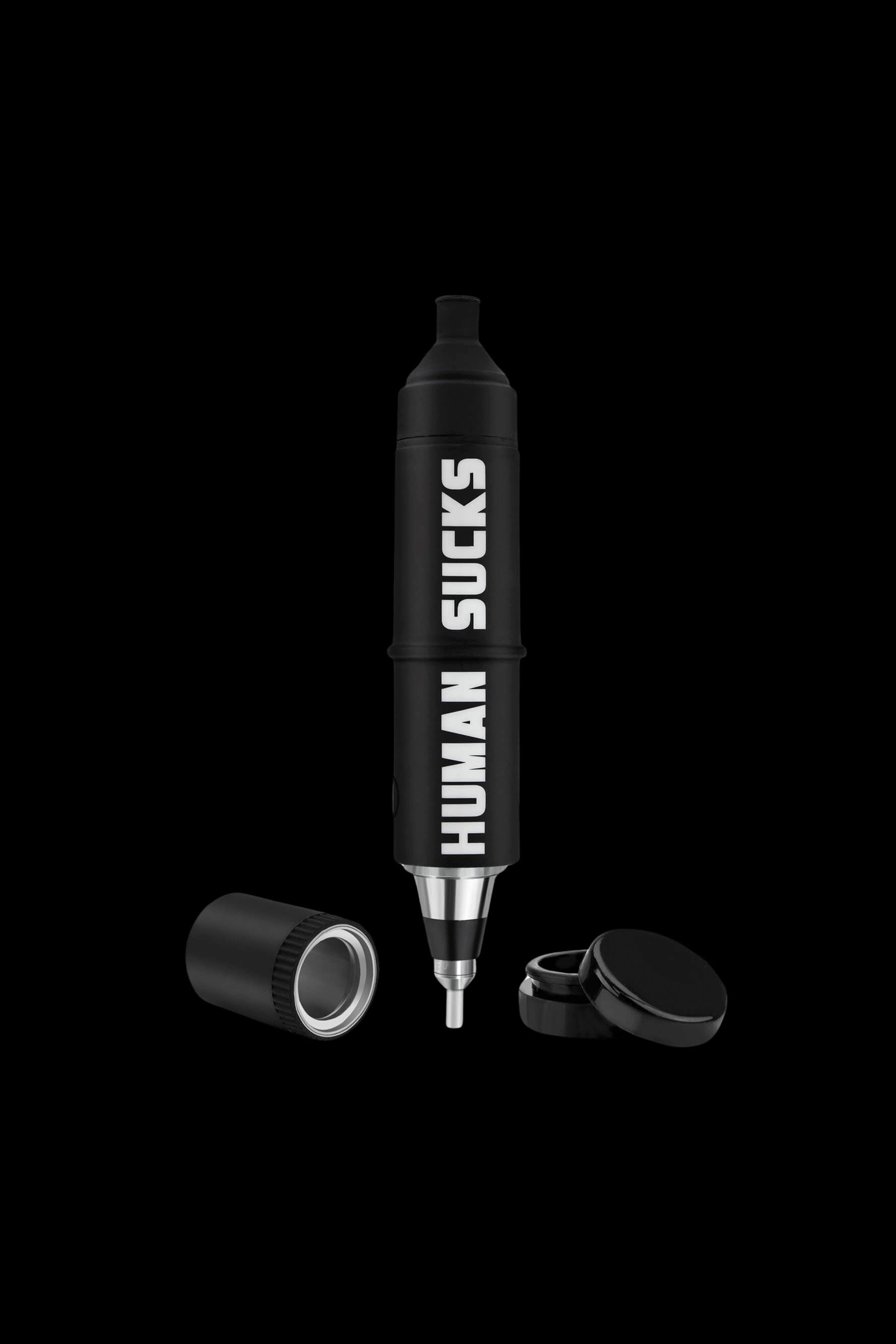 Black cannabis dab pen with “HUMAN SUCKS” text vertically along the side, disassembled with caps nearby on a black background.