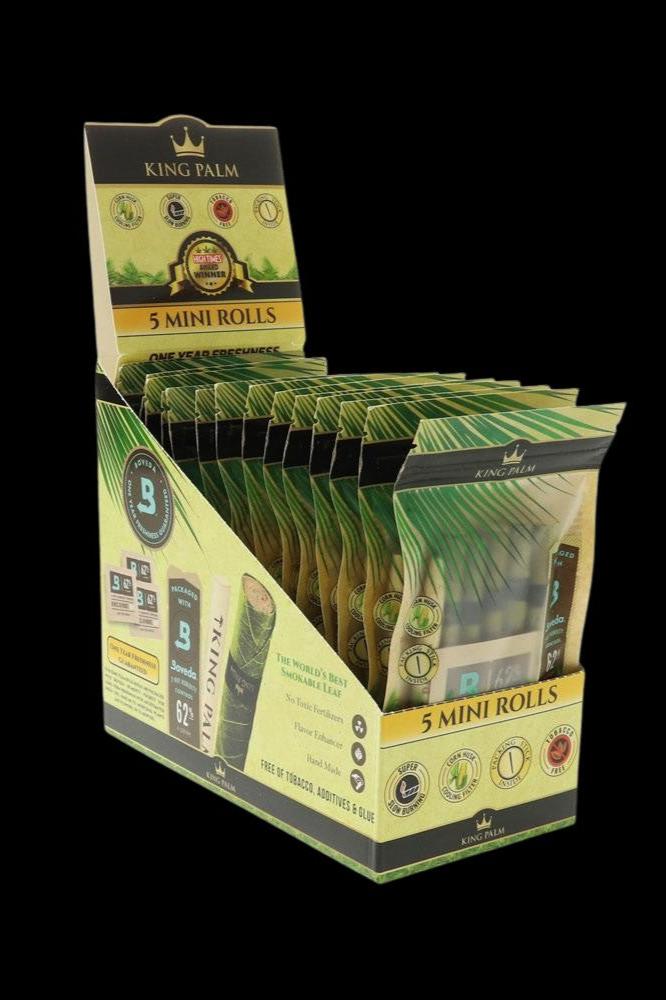A stack of green King Palm rolling papers in a branded box.