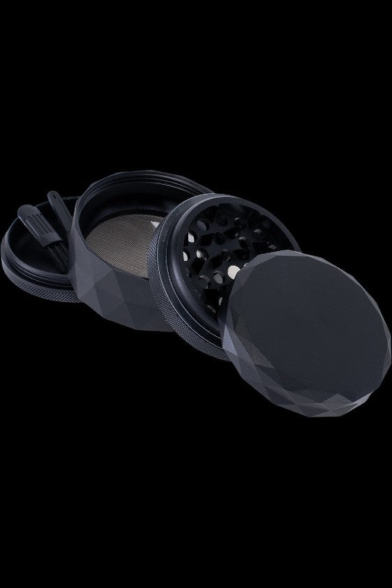 Black cannabis grinder partially disassembled, showing internal grinding components.