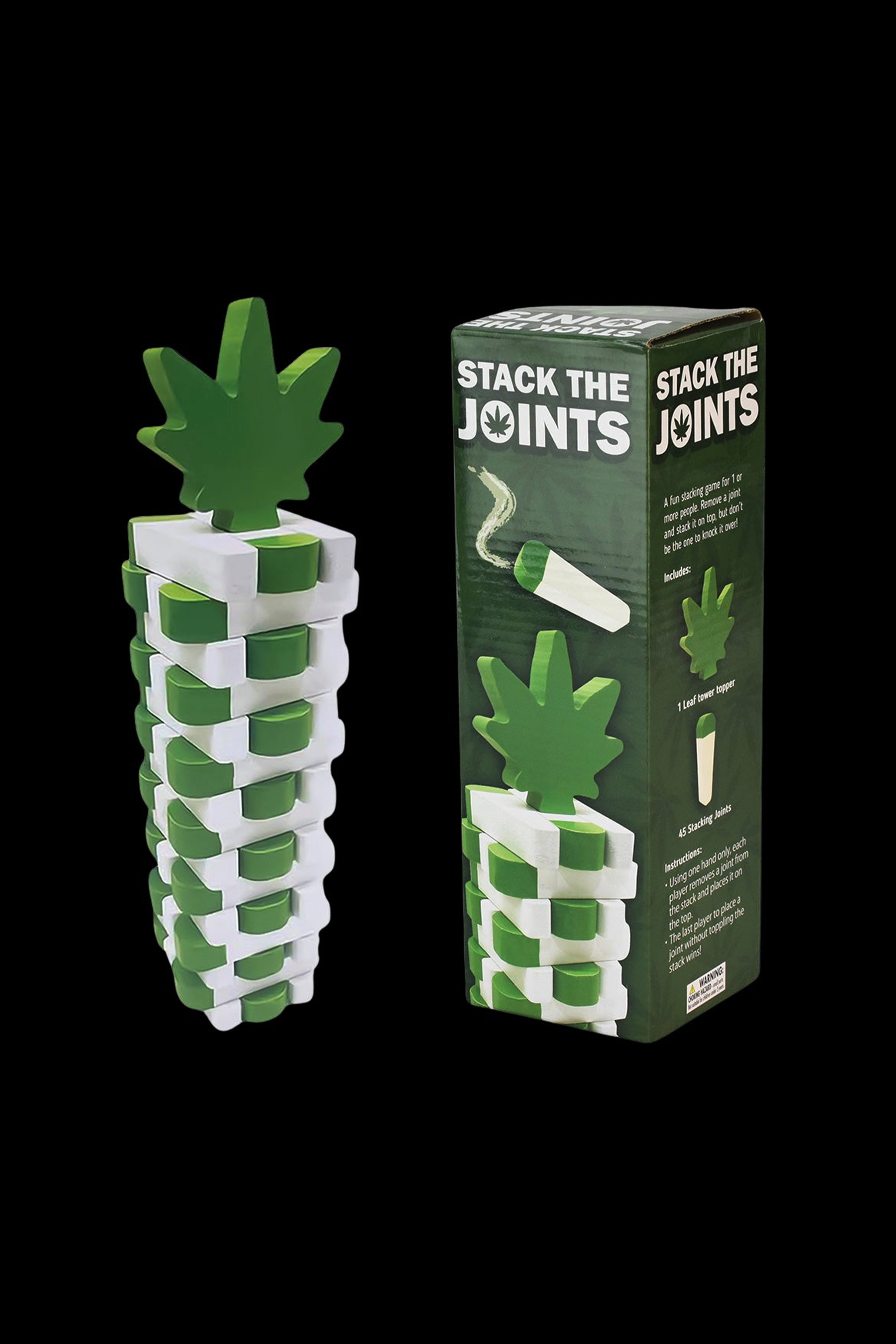 A green cannabis-leaf shaped tower made of stacked, cylindrical “joints” with a single leaf topper, displayed beside the game box labeled “Stack the Joints.”
