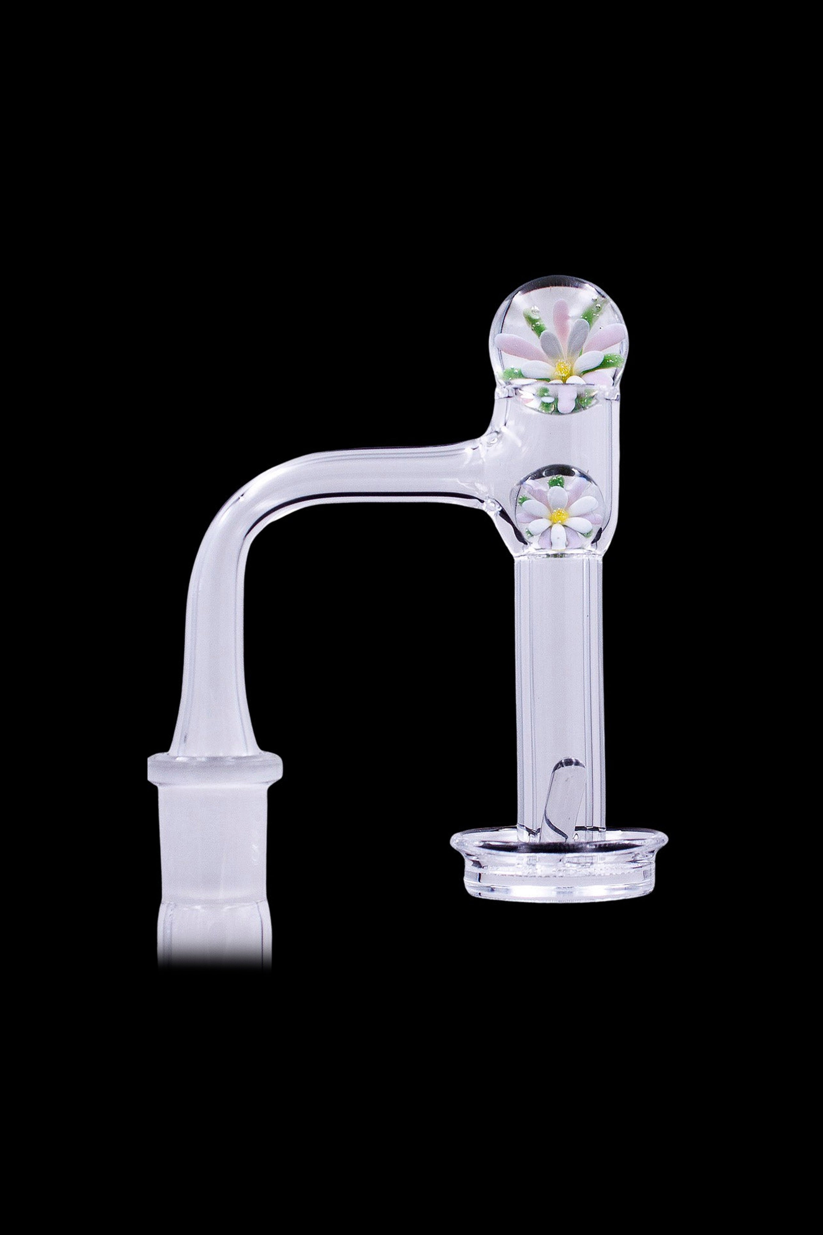 Clear glass cannabis oil rig with floral detailing.