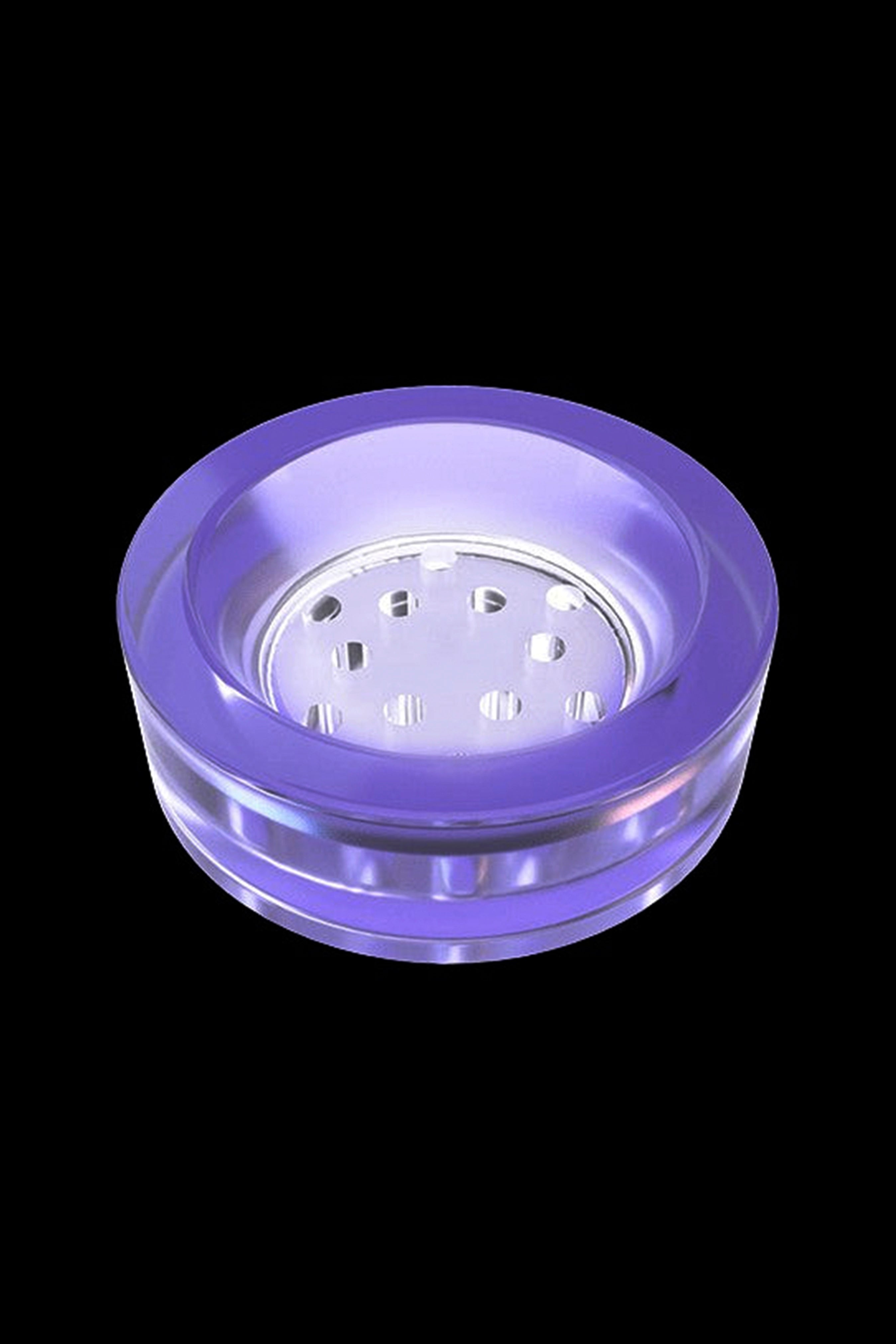 Purple glass pipe bowl with numerous holes.