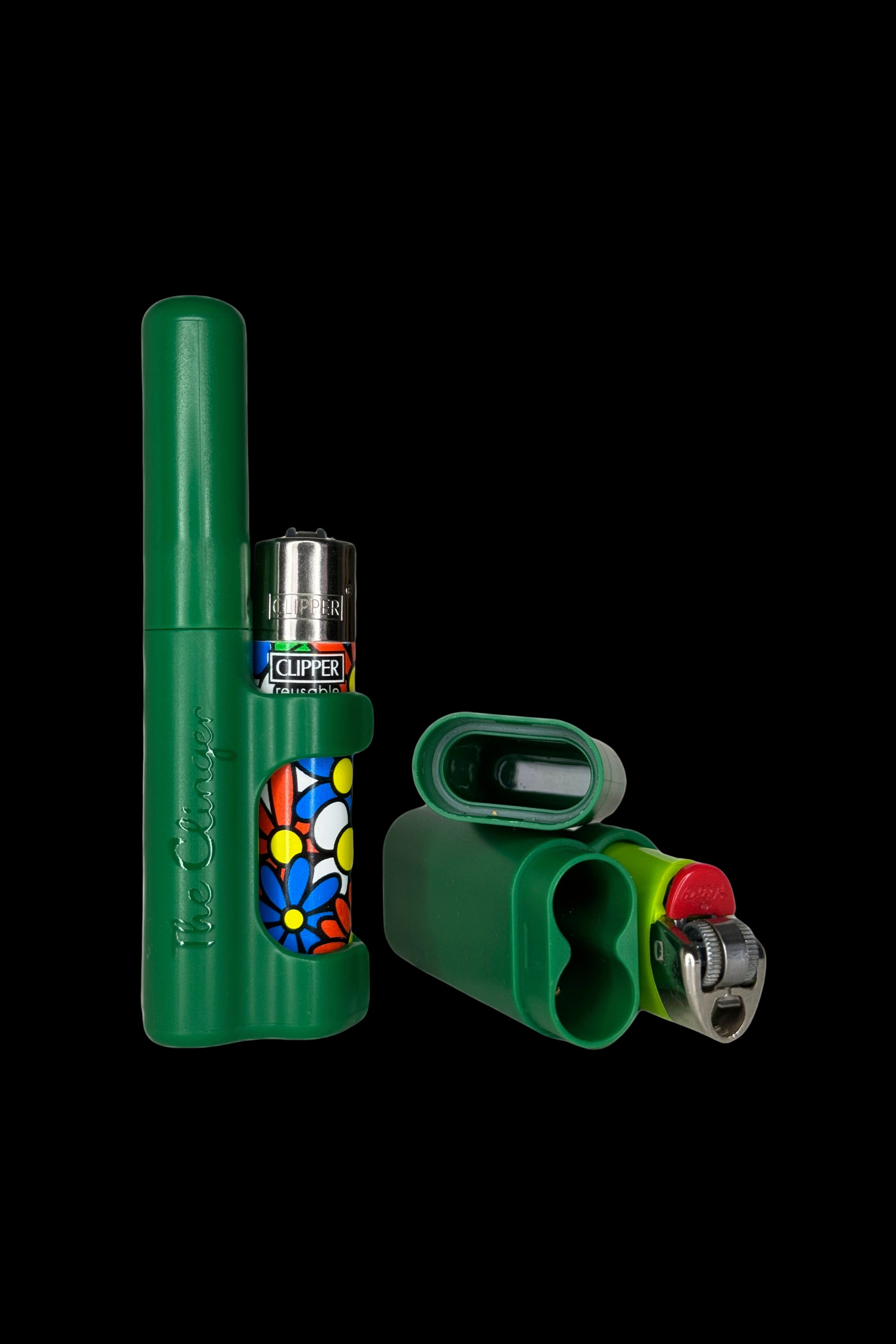 Green cannabis accessories including a vaporizer pen, lighter, and storage case against a black background.