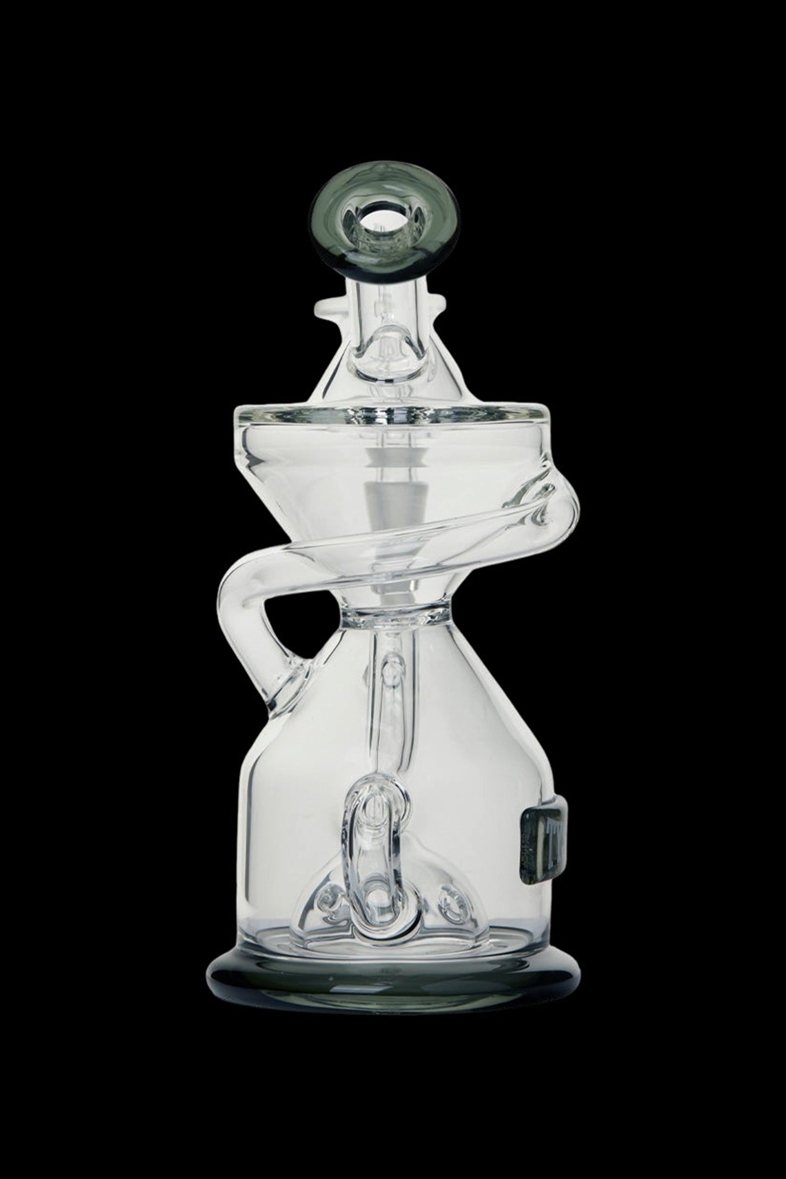 Clear glass dab rig with intricate curves and a bubbler design, isolated on a black background.