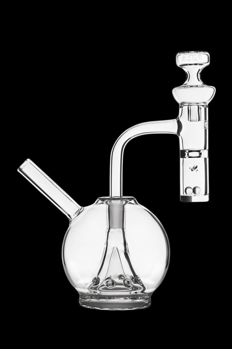 Clear glass bubbler and dab rig set against a black background.