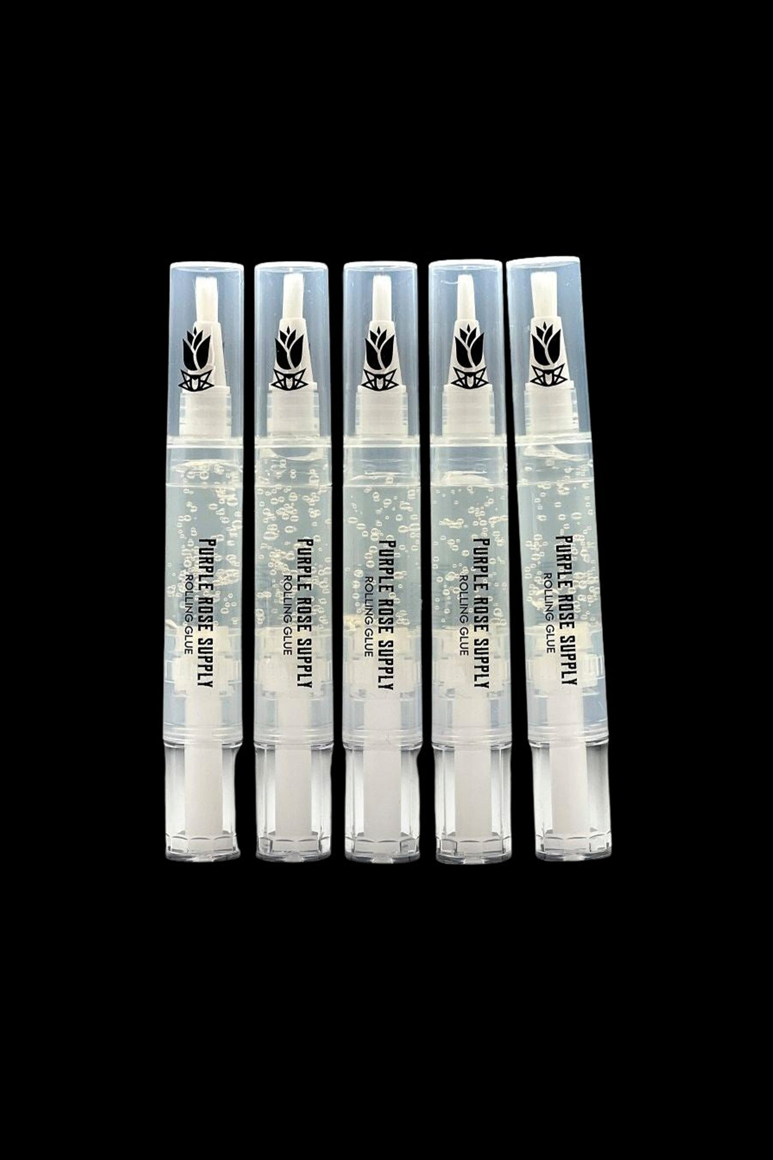 Close-up front view of five clear gel pens labeled Purple Rose Supply Cannagar & Blunt Rolling Glue standing upright against a black background.
