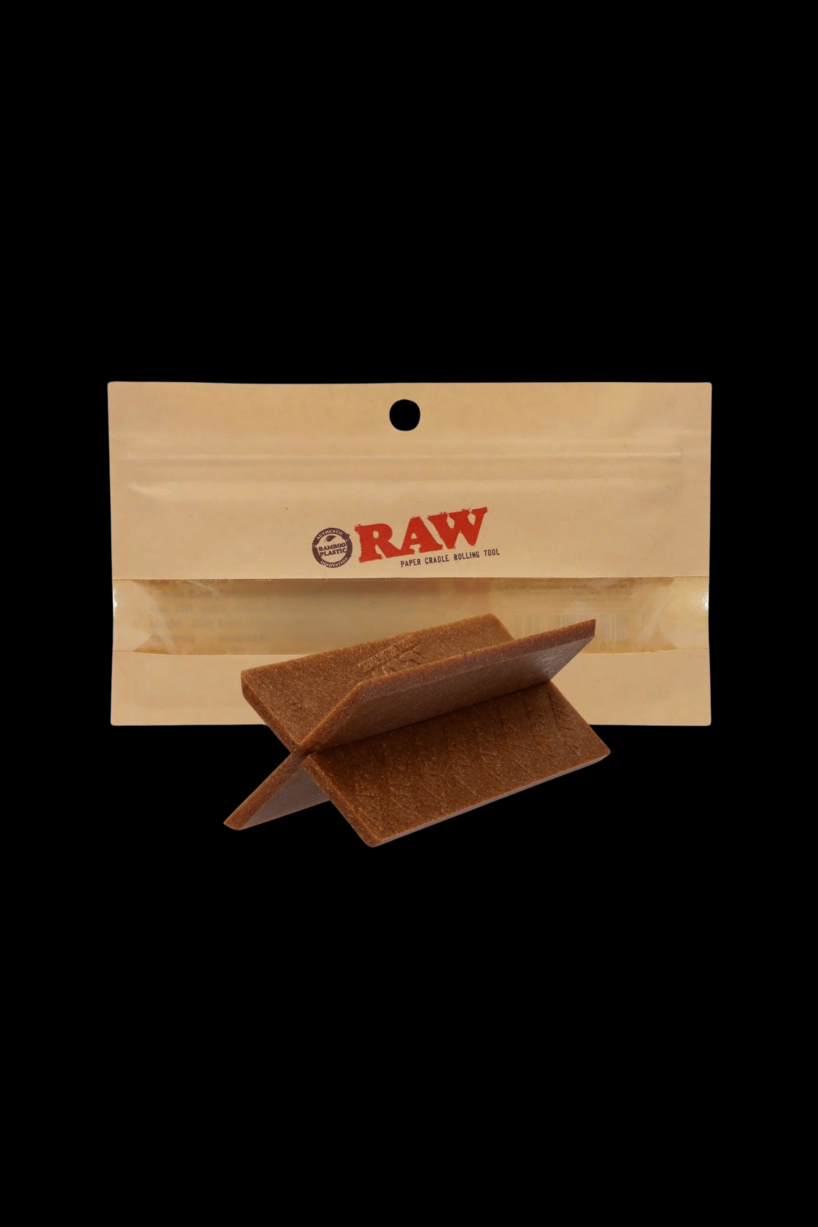 Raw paper cradle rolling tool on a beige background.