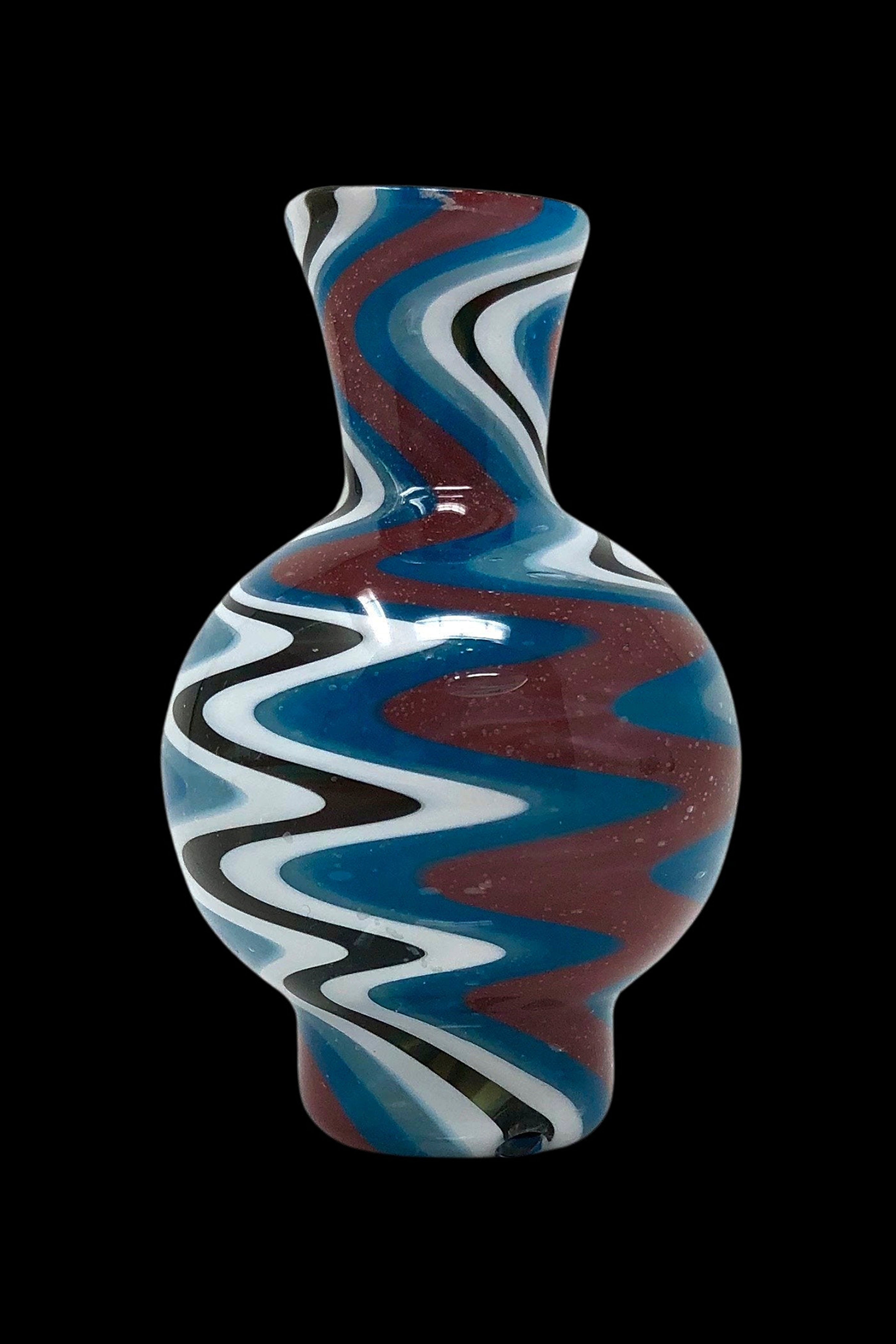 Hand-blown glass water pipe with red, blue, and white swirling patterns.