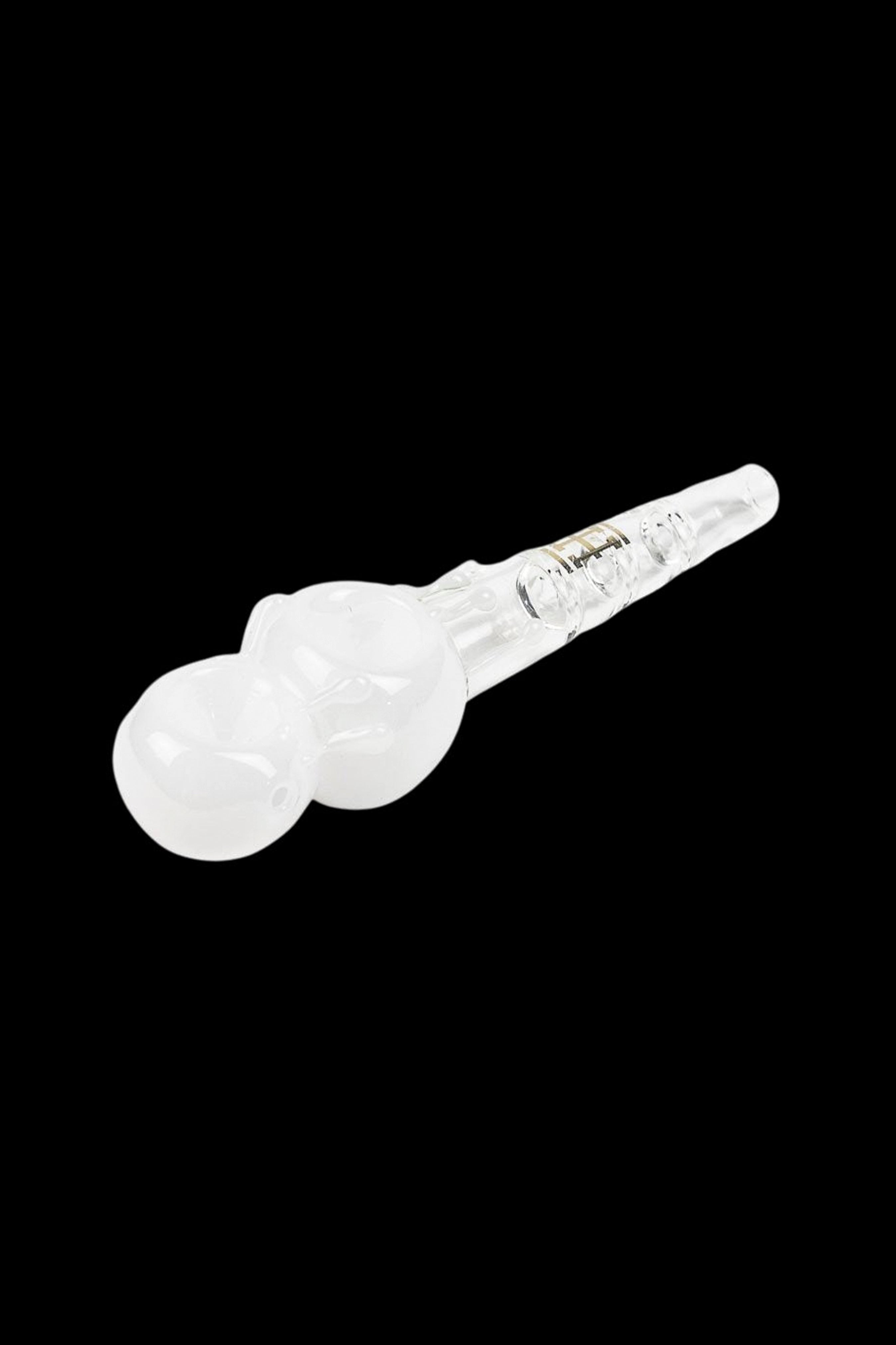 White glass cannabis oil burner pipe isolated on a black background.