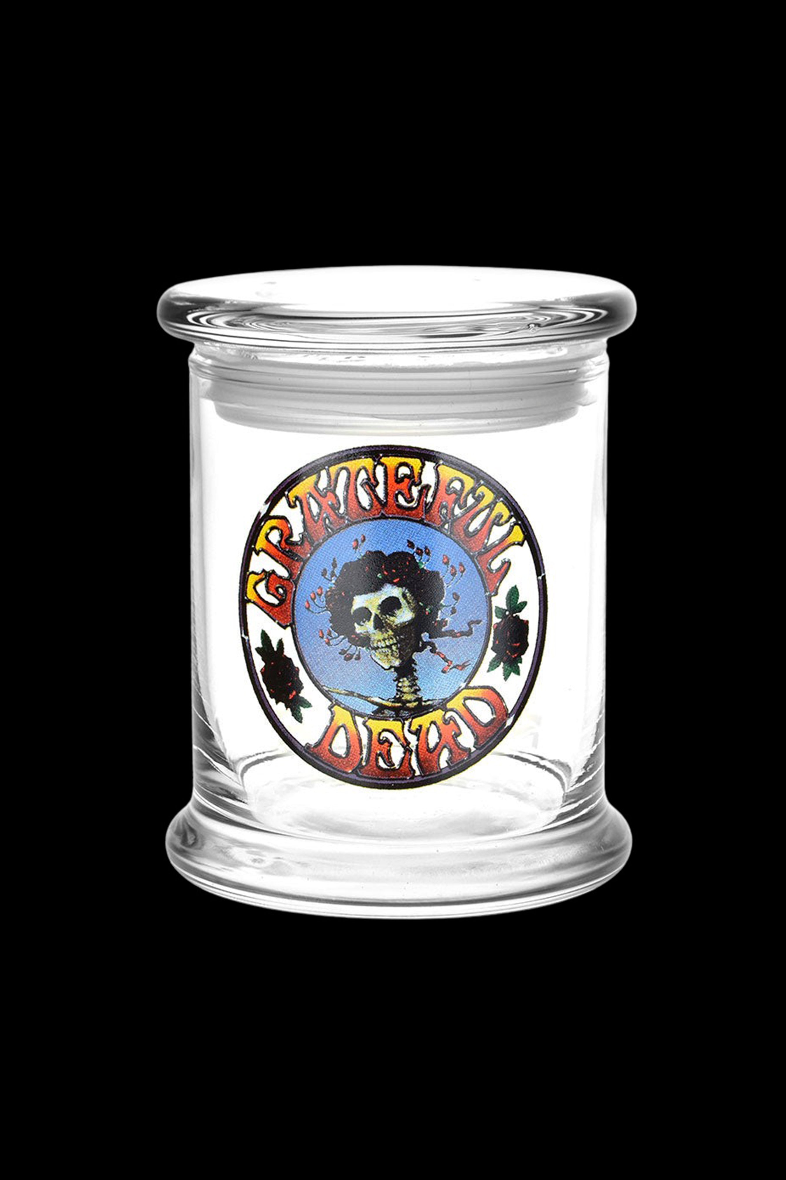 Clear glass jar with a Grateful Dead-inspired skull and leaves design, likely for cannabis storage.