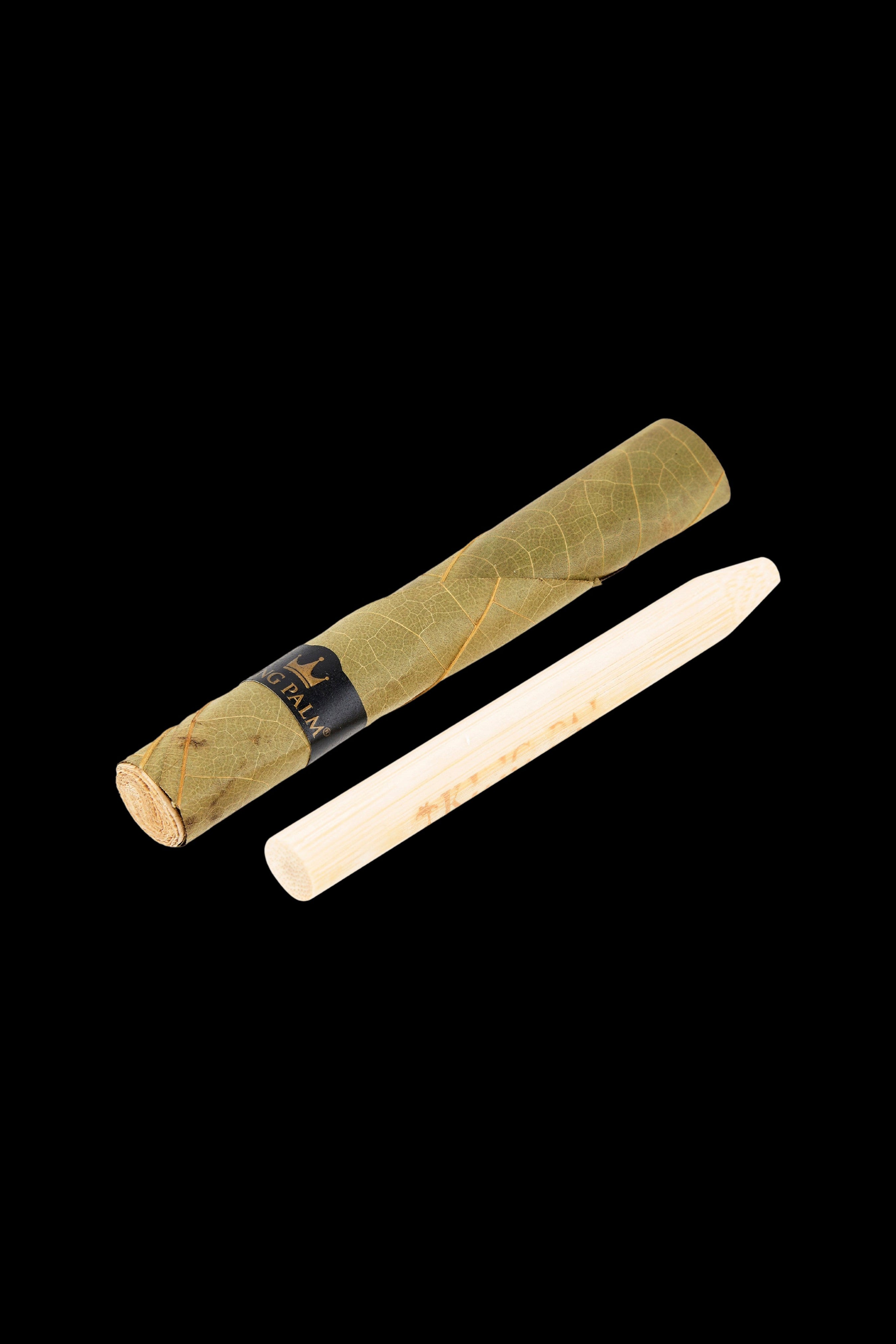 Two rolled cannabis blunts, one wrapped in a light brown palm leaf and the other in white paper, against a black background.