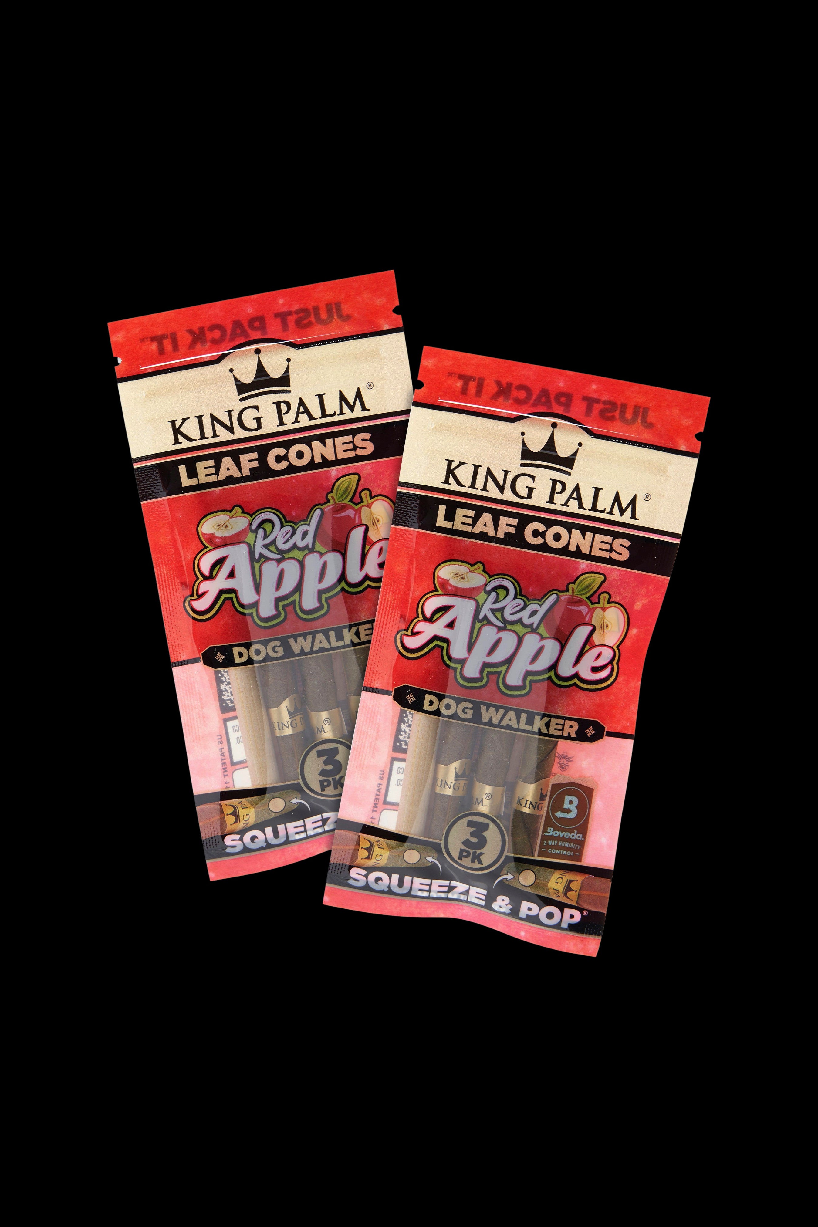 Two packs of “King Palm” red apple flavored rolling cones against a black background.