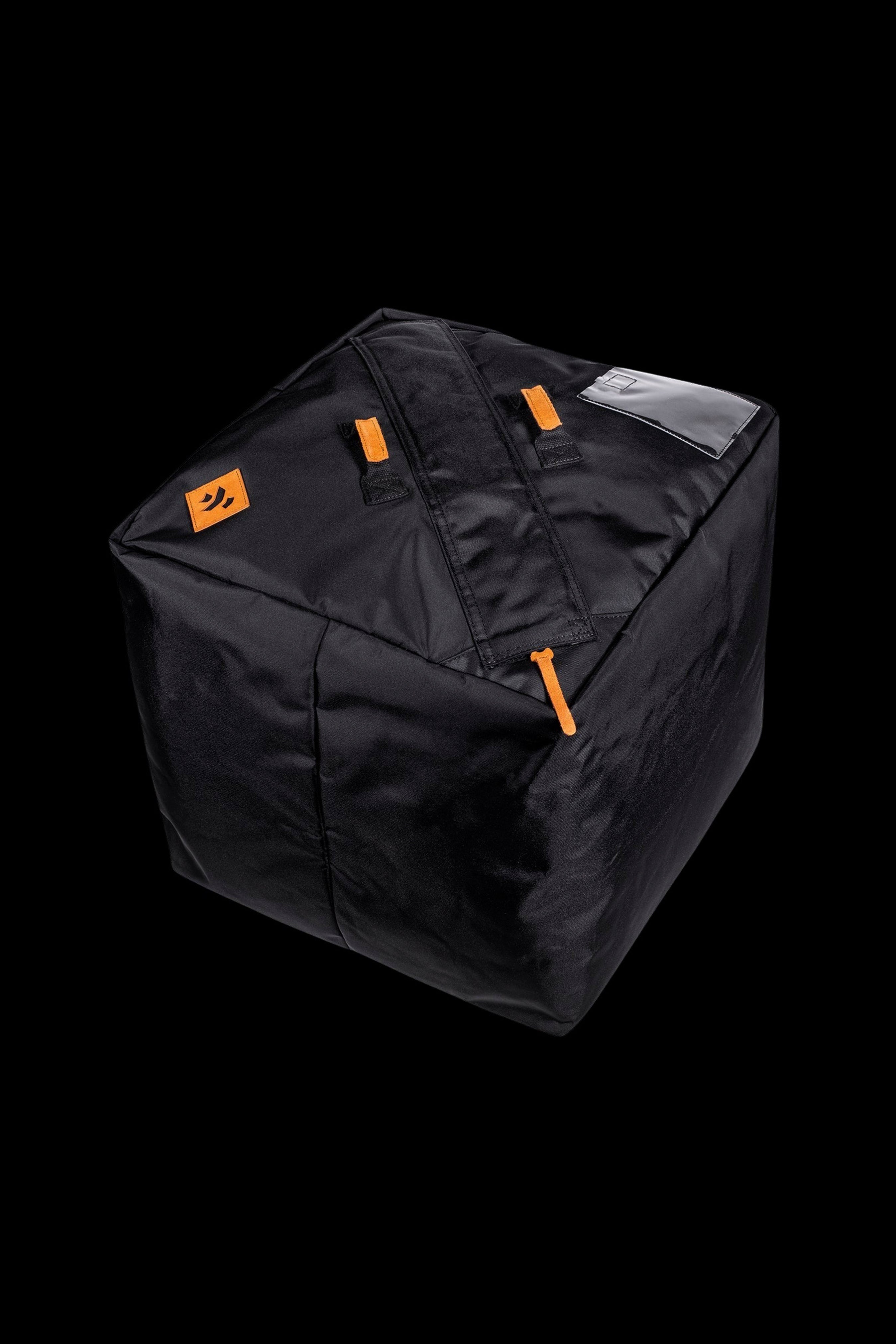 Black, padded smell-proof bag shaped like a cube with orange zipper pulls, isolated on a black background.