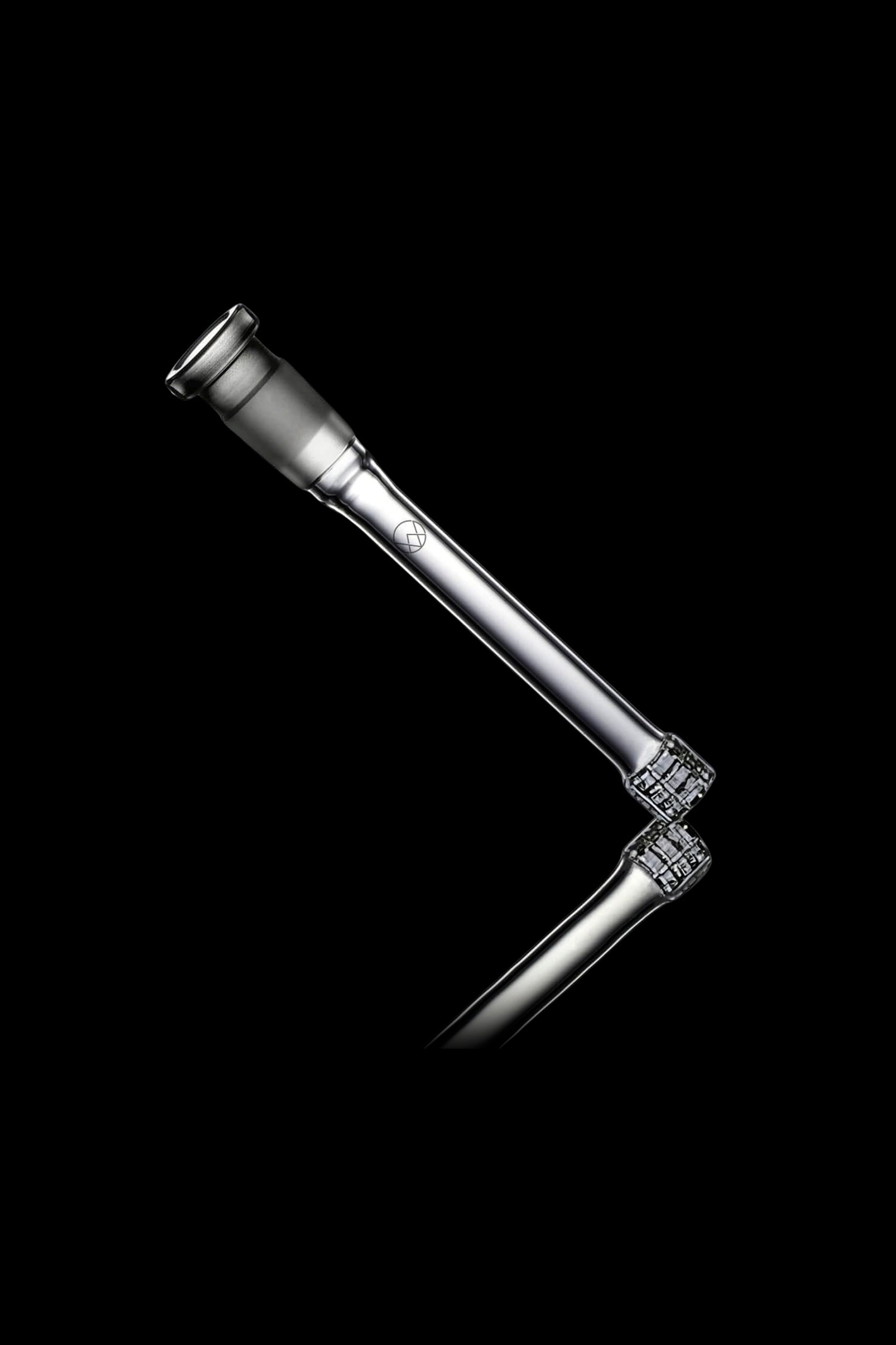 A sleek, silver cannabis oil rig with diamond-encrusted accents, set against a black background.