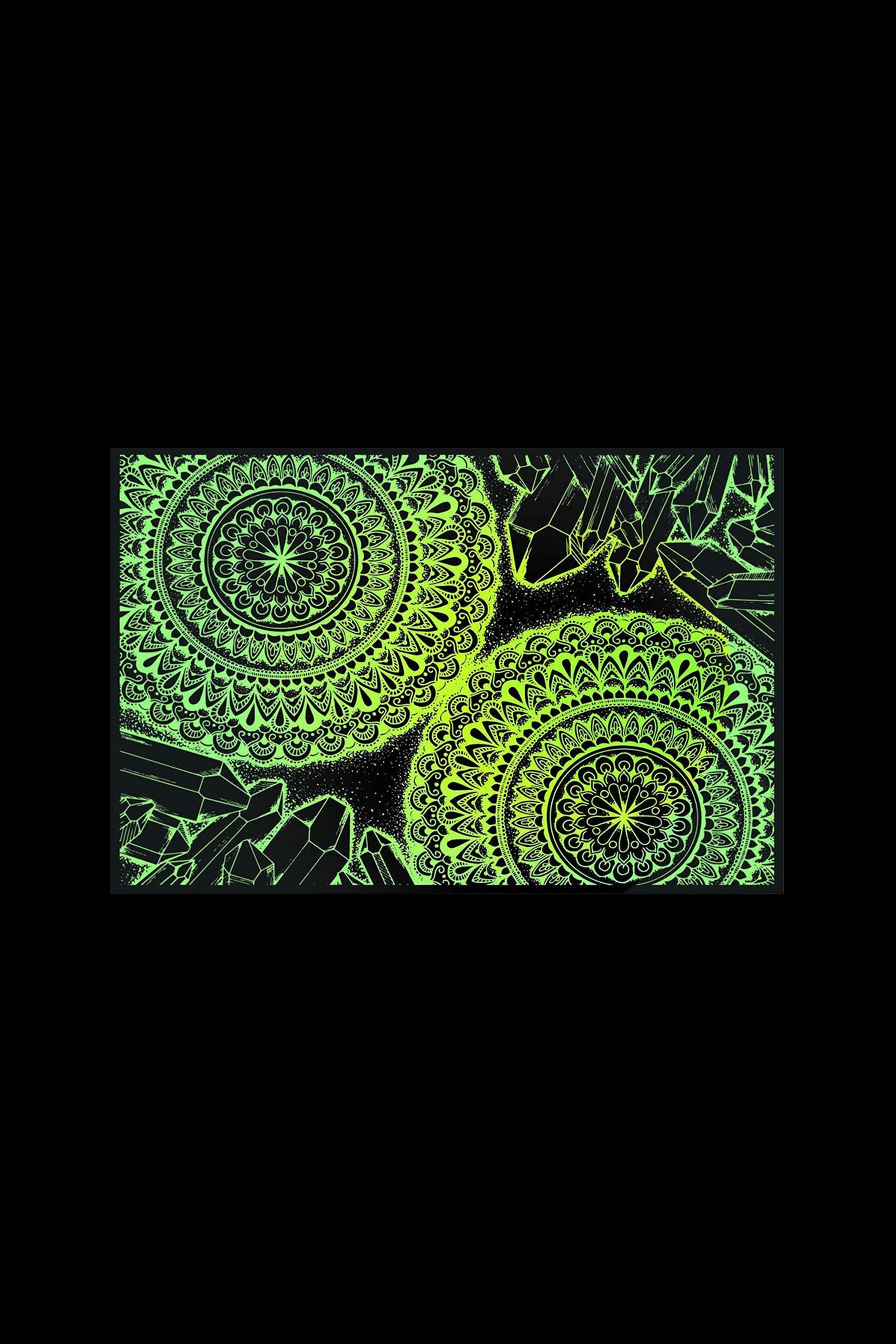 Glowing green mandala pattern with crystal shapes on a black background.