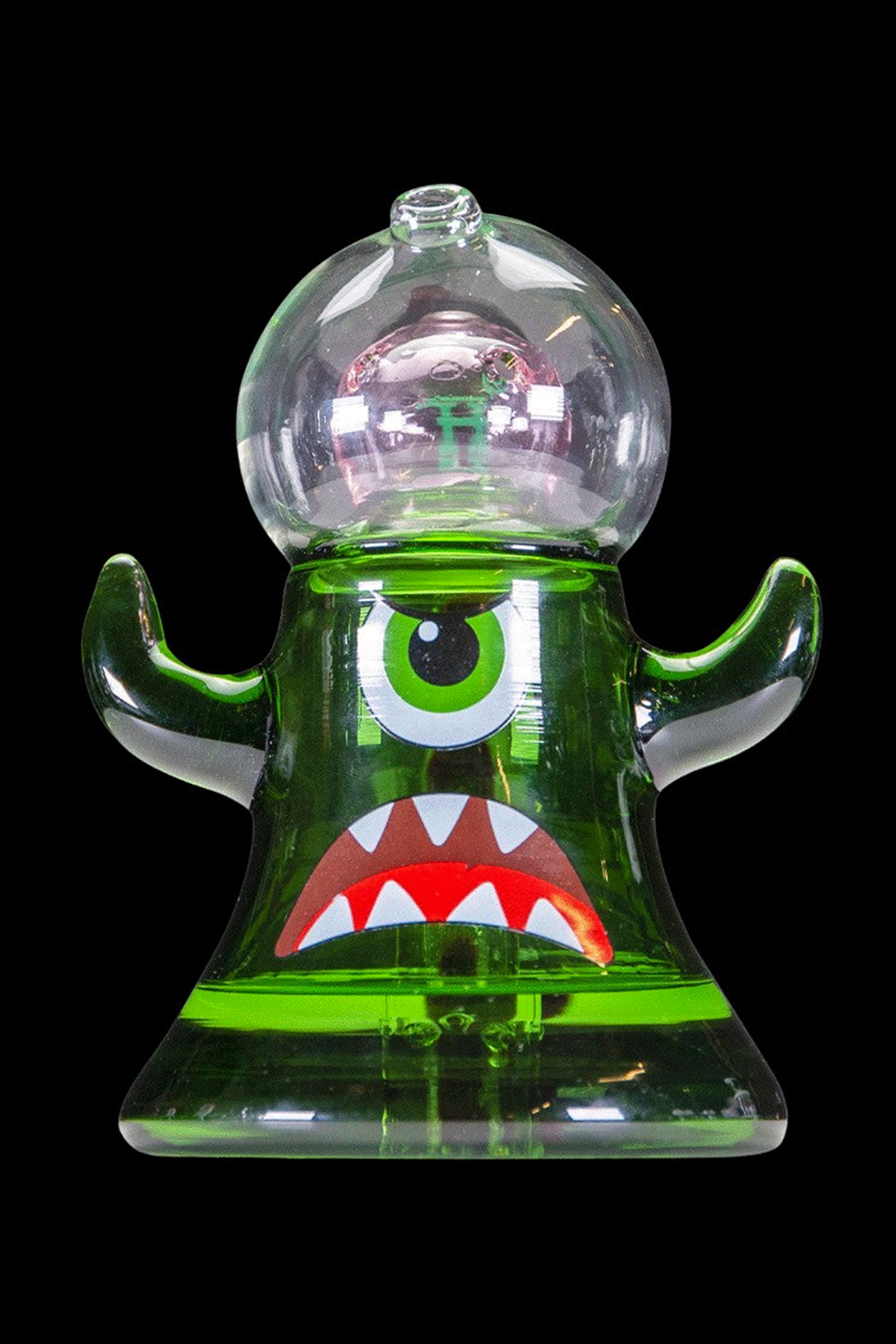 Green glass monster-themed rig with colorful accents, isolated on black.