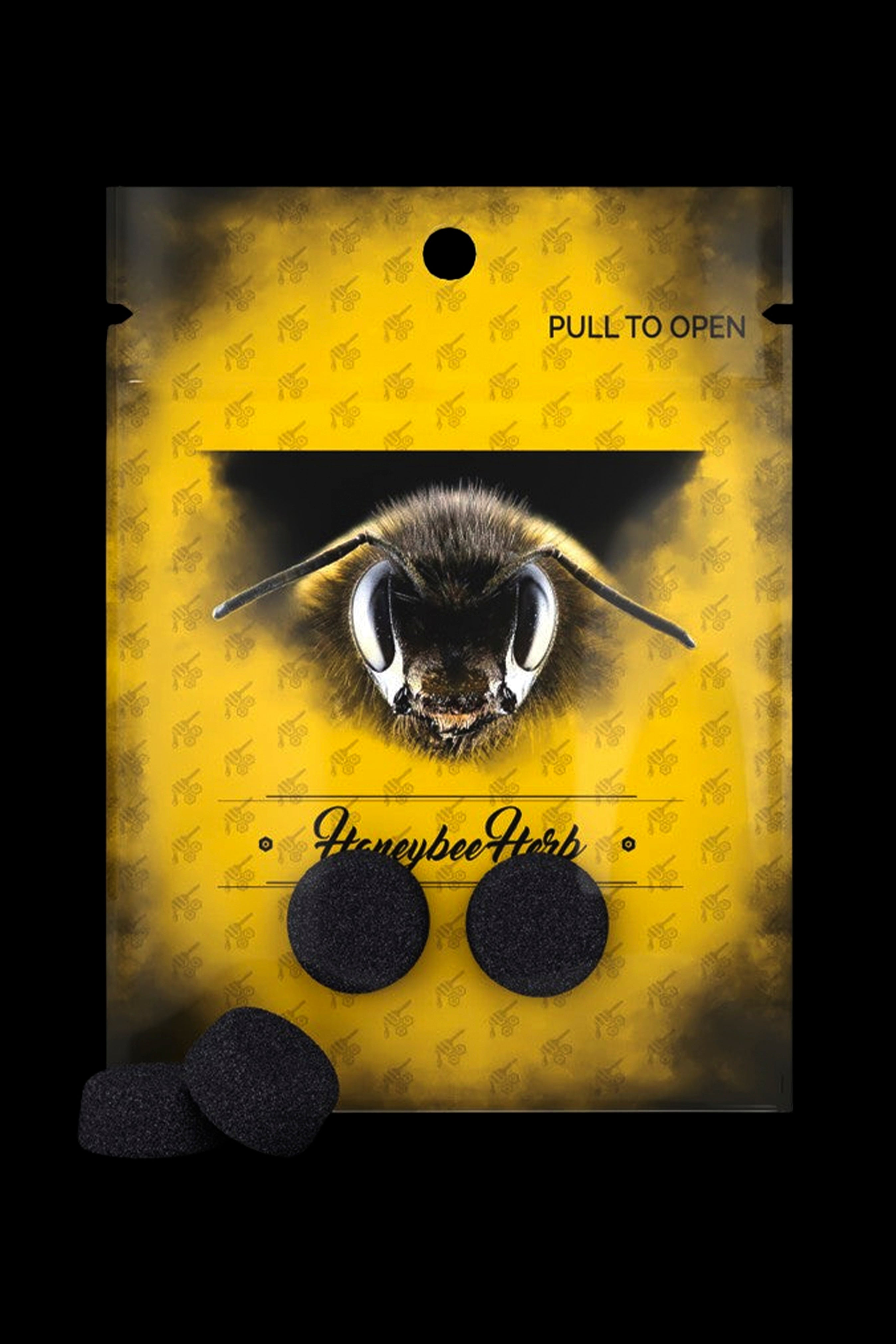 Yellow pouch labeled “Honeybee Herb” displaying three black cannabis rosin discs, adorned with a close-up image of a bee.