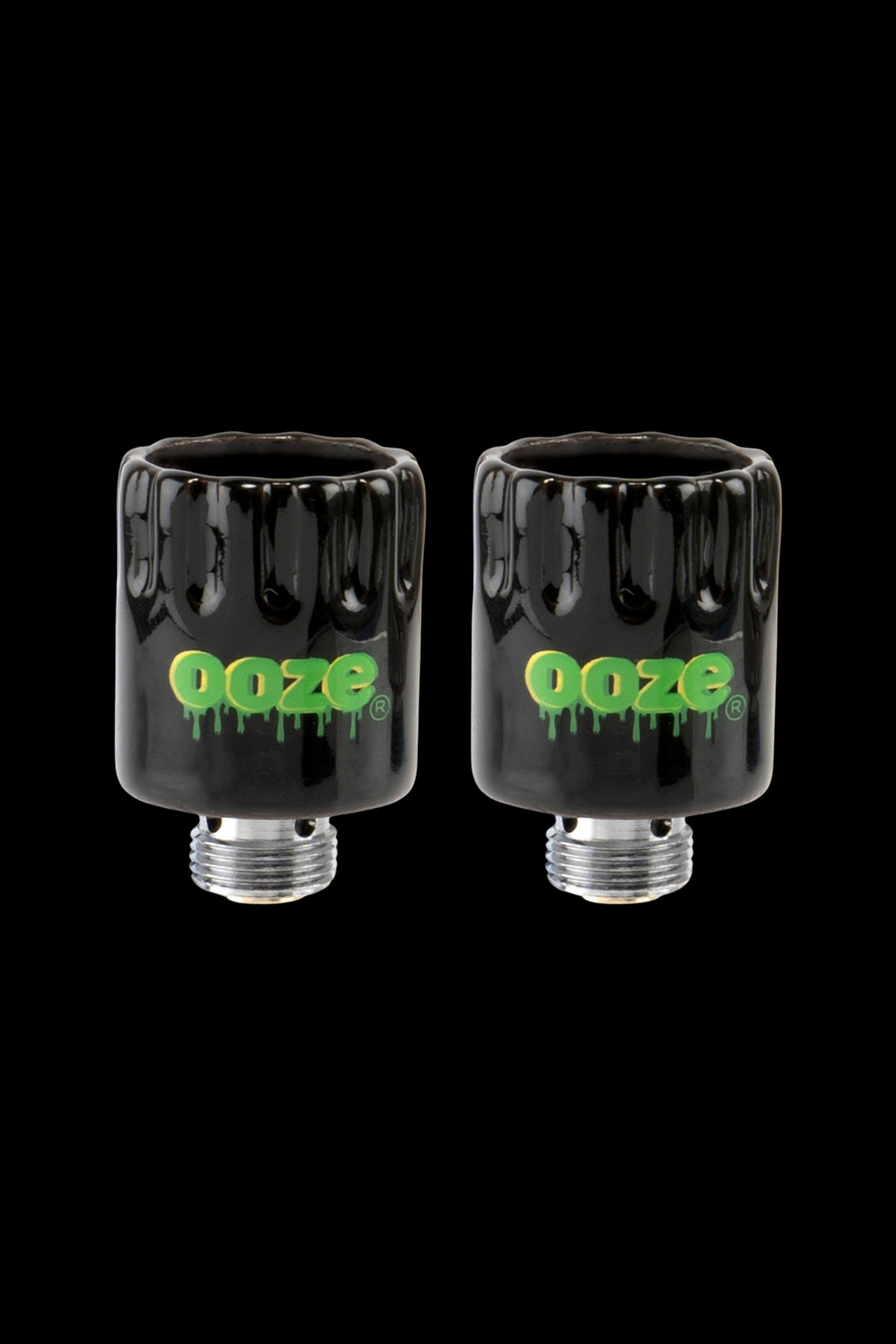 Two black glass cartridges with the “Ooze” logo in green, displayed against a black background.