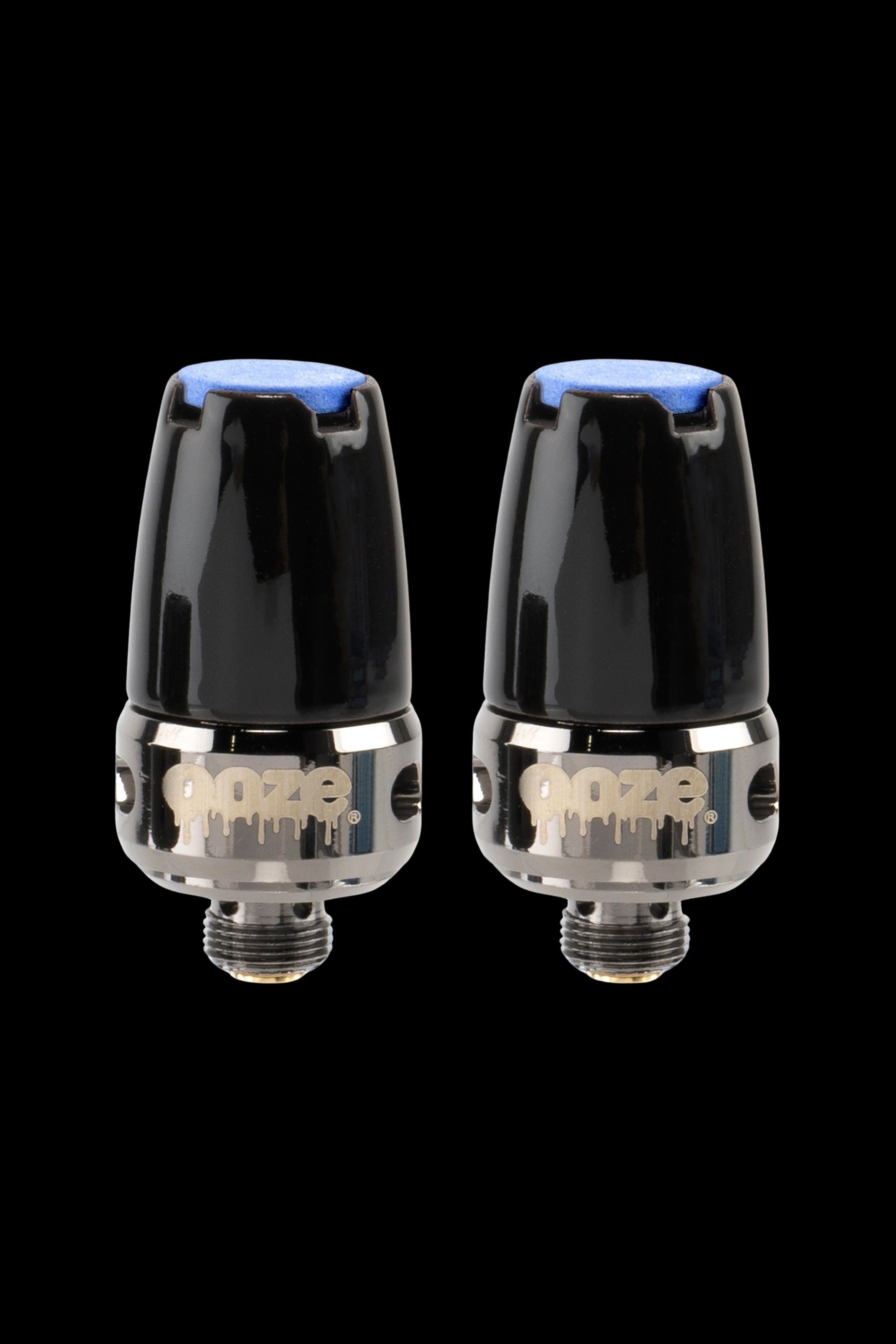 Two Dynavap M cannabis vaporizers against a black background.