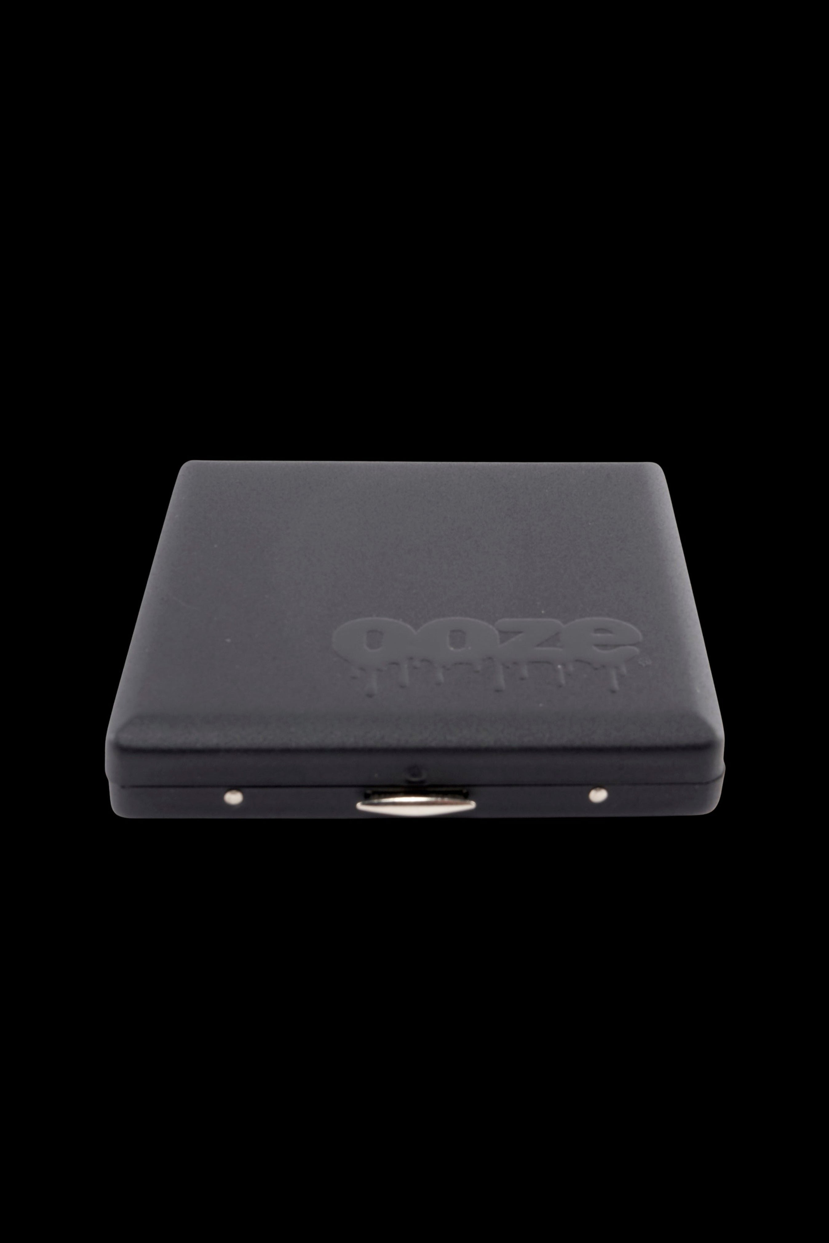 Close-up front view of a black Ooze Joint Case with its embossed logo visible on the lid against a black background.