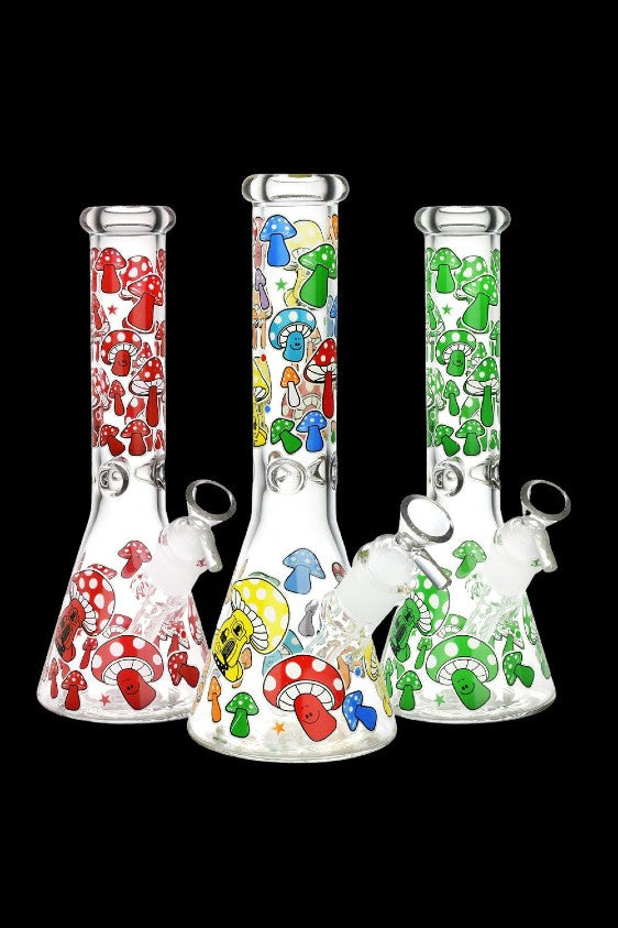 Three glass bongs decorated with colorful mushroom designs against a black background.
