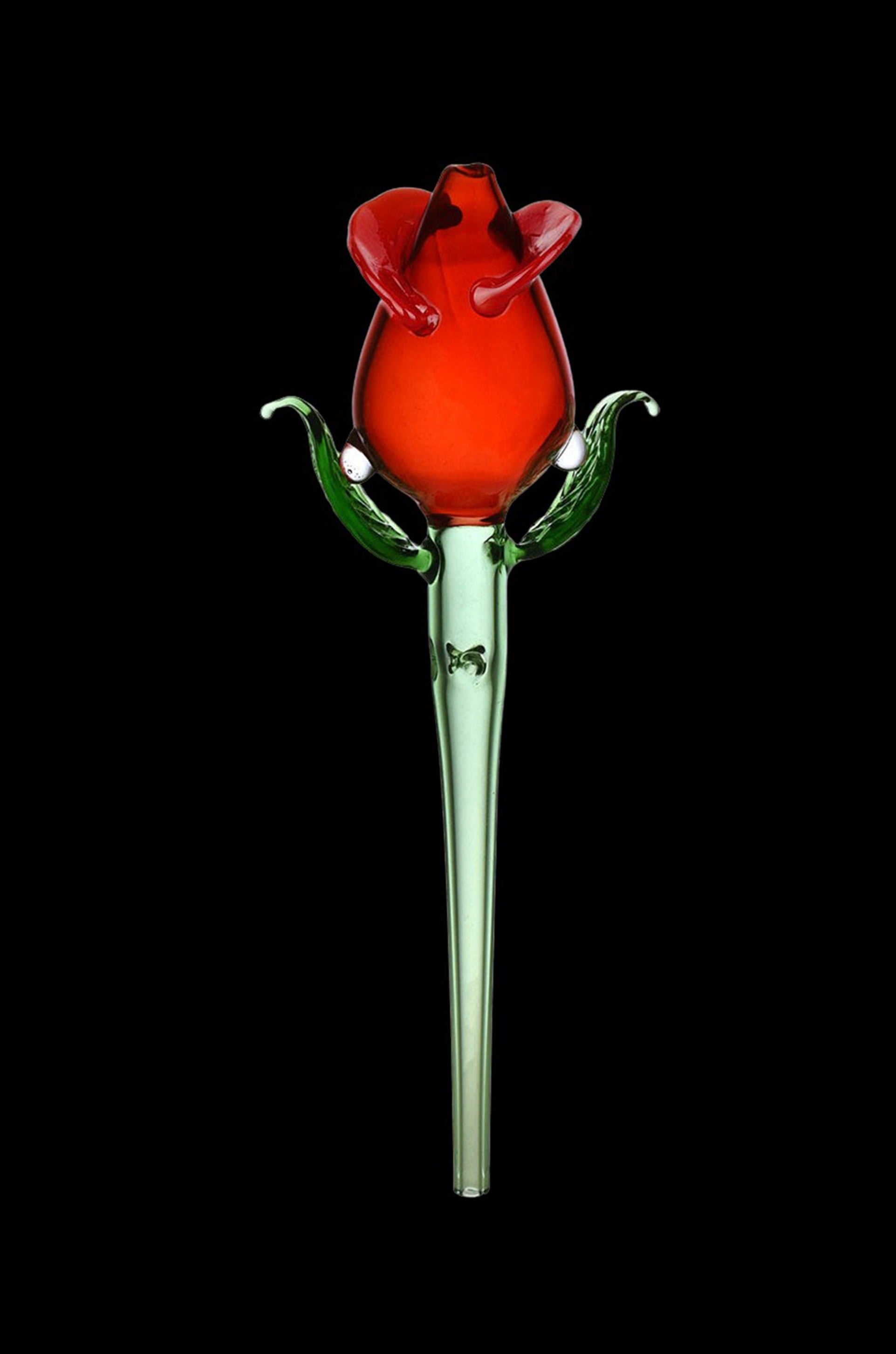 Red glass cannabis pipe shaped like a rose with green leaf accents, against a black background.