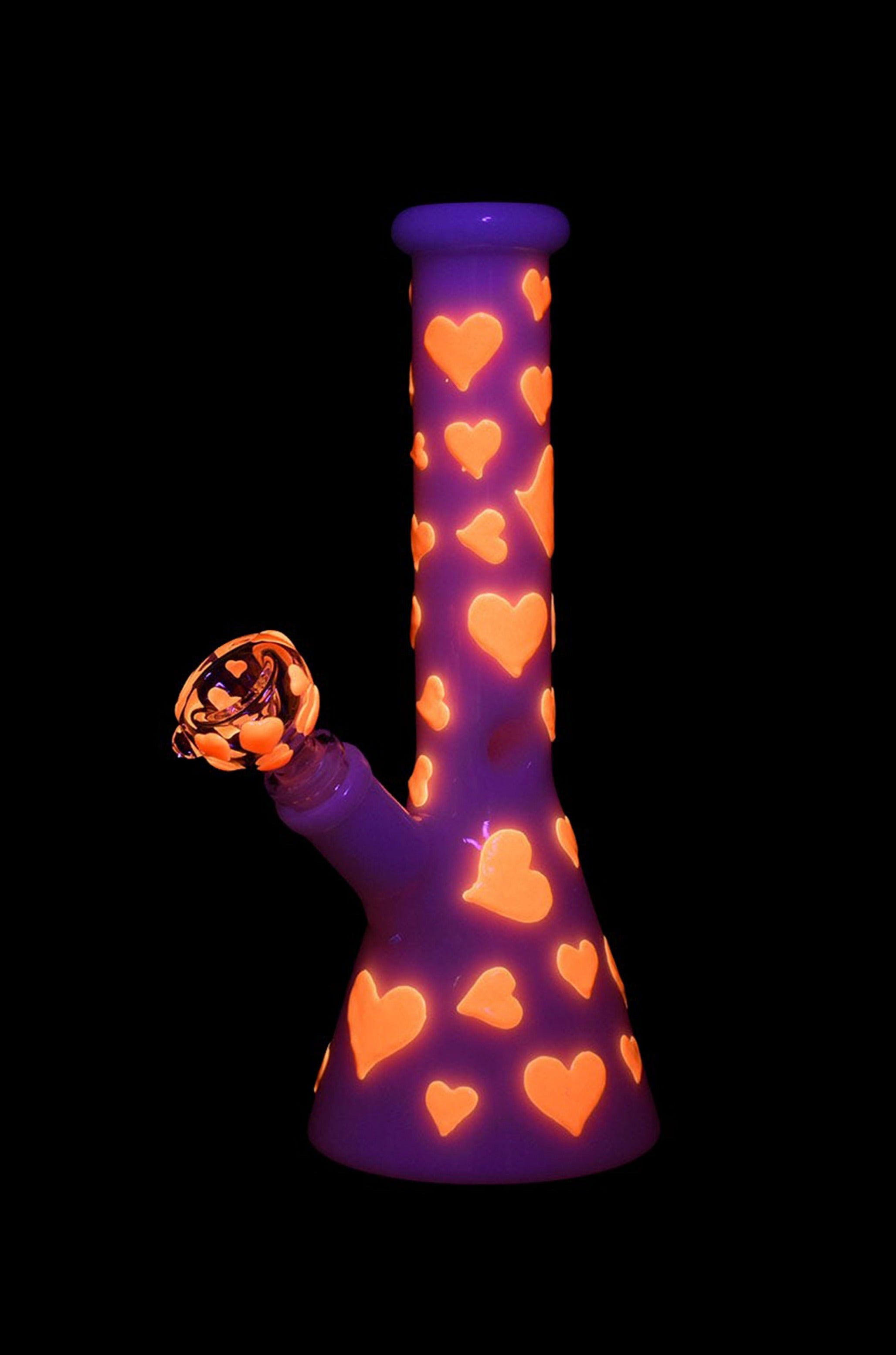 Purple glass bong decorated with orange hearts, isolated on black.