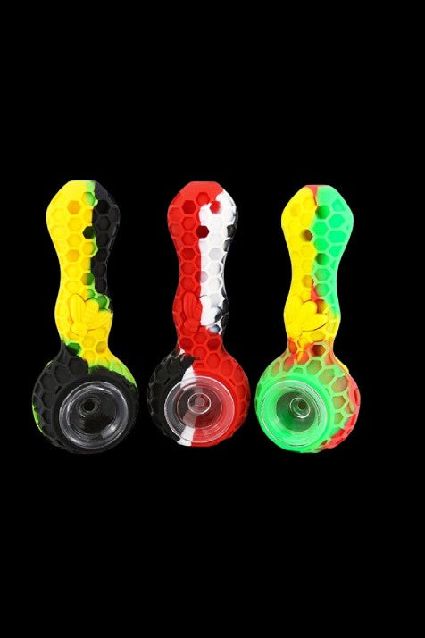 Colorful silicone smoking pipes arranged in a row on a black background.