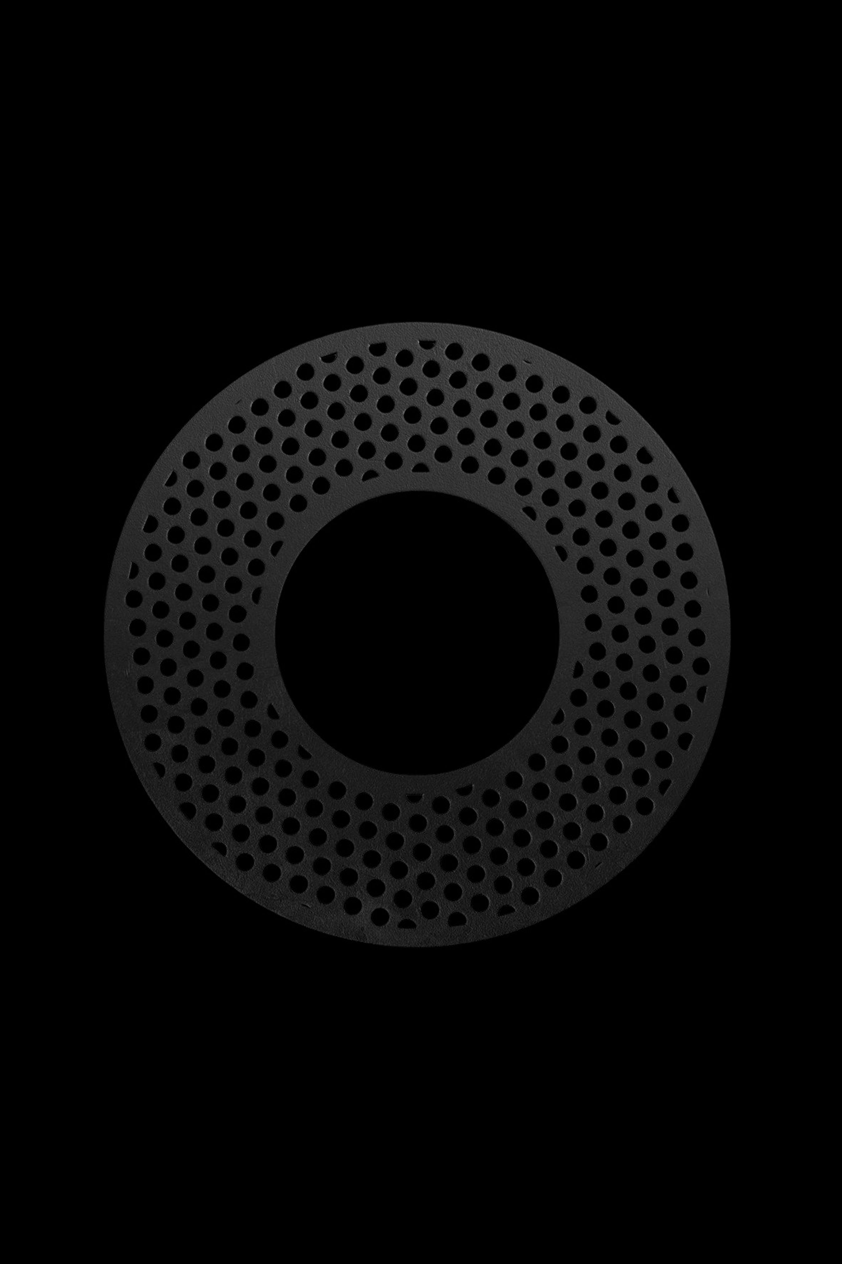 Black metal smoking bowl screen with perforated holes.