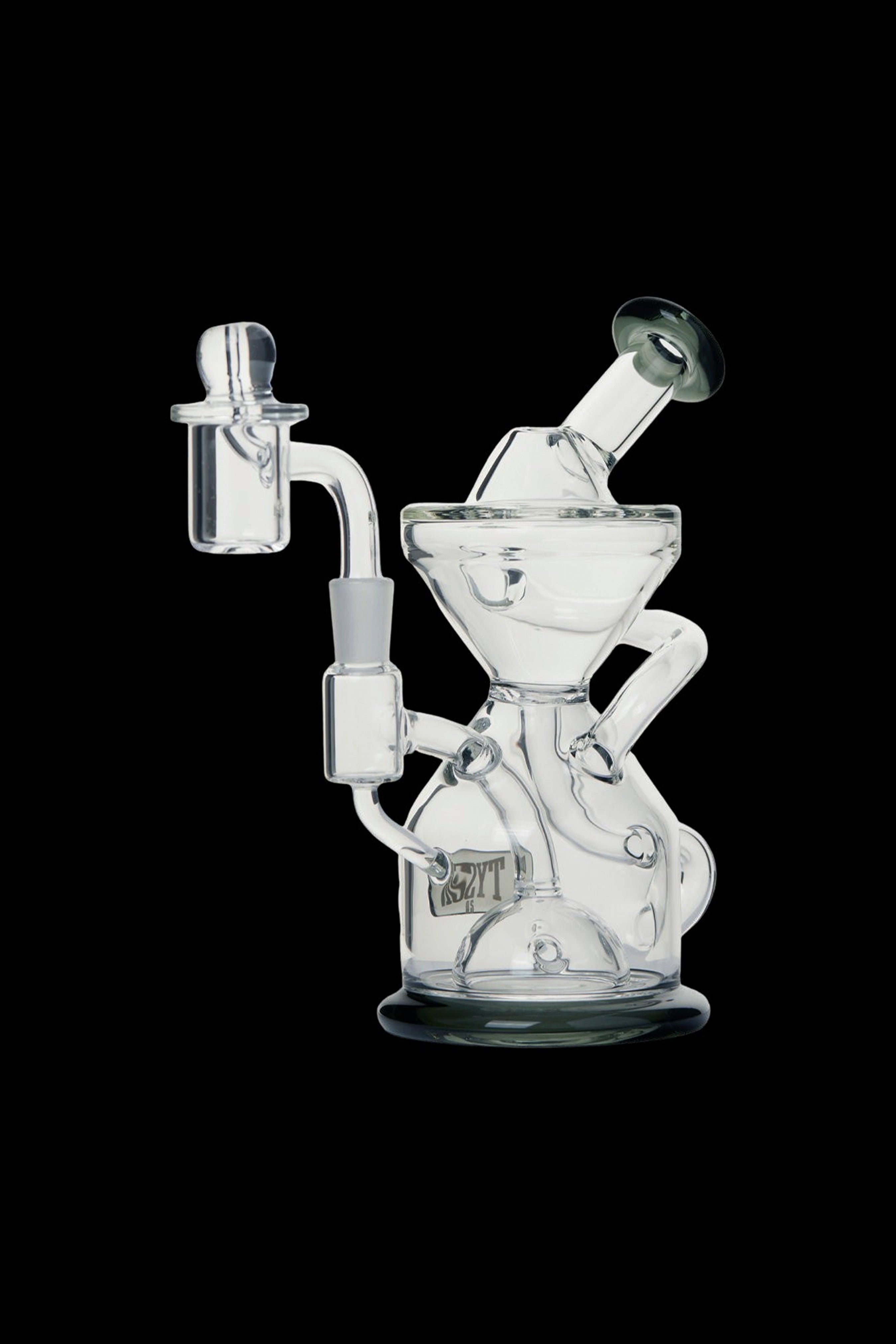 Clear glass water pipe (rig) with intricate design and detachable bowl, isolated on a black background.
