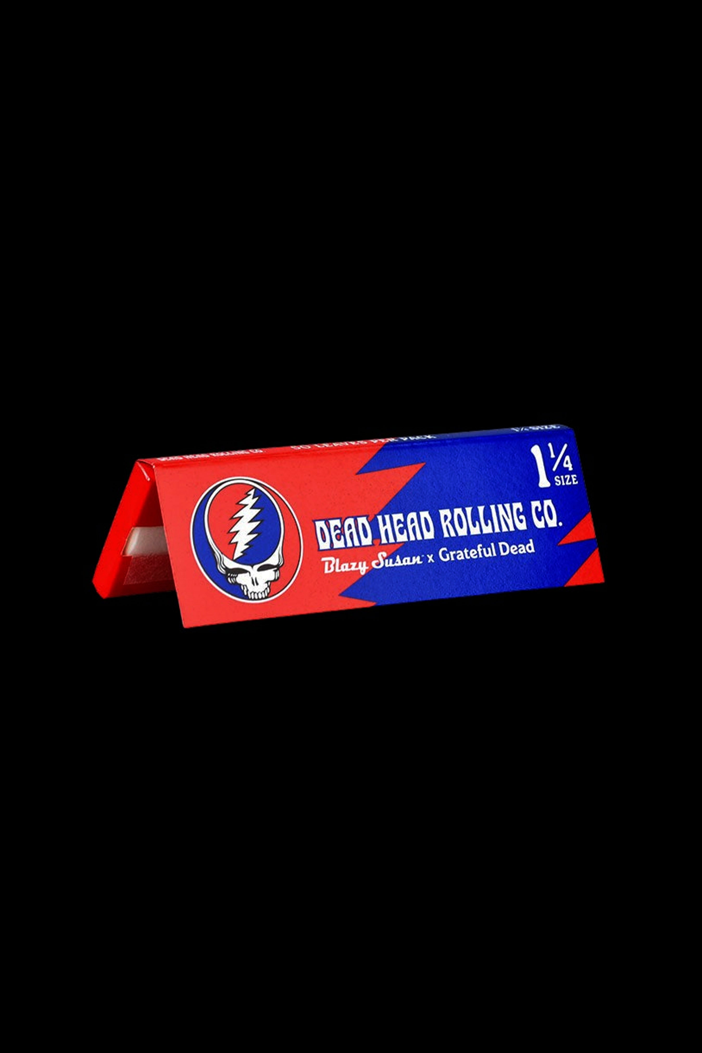 Pack of 1¼ size rolling papers branded with the Grateful Dead's "Steal Your Face" skull logo and "Blazy Susan Rolling Co." text on a black background.