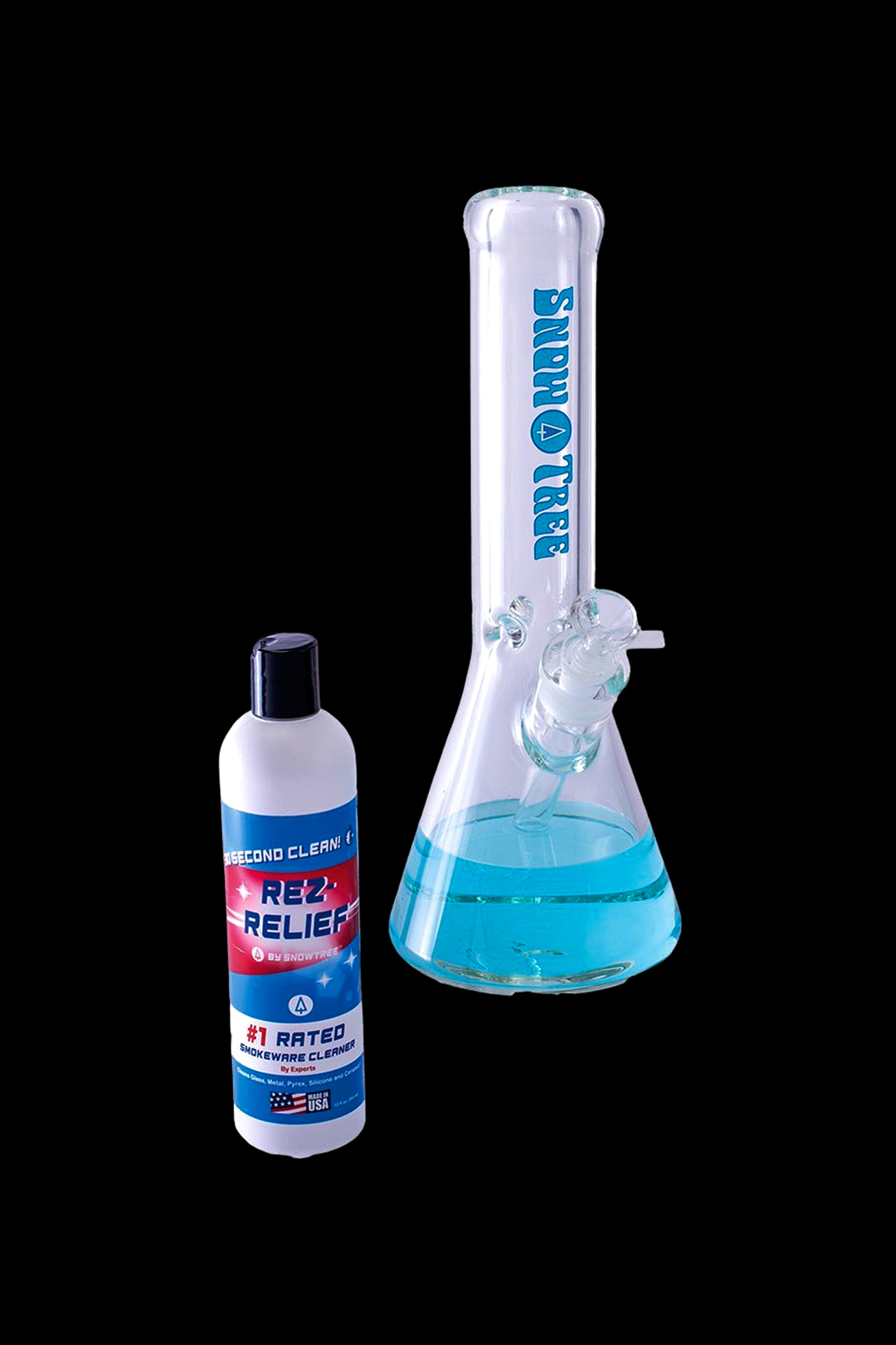 A bottle of Rez Relief glass cleaner positioned next to a clean glass bong on a white surface.