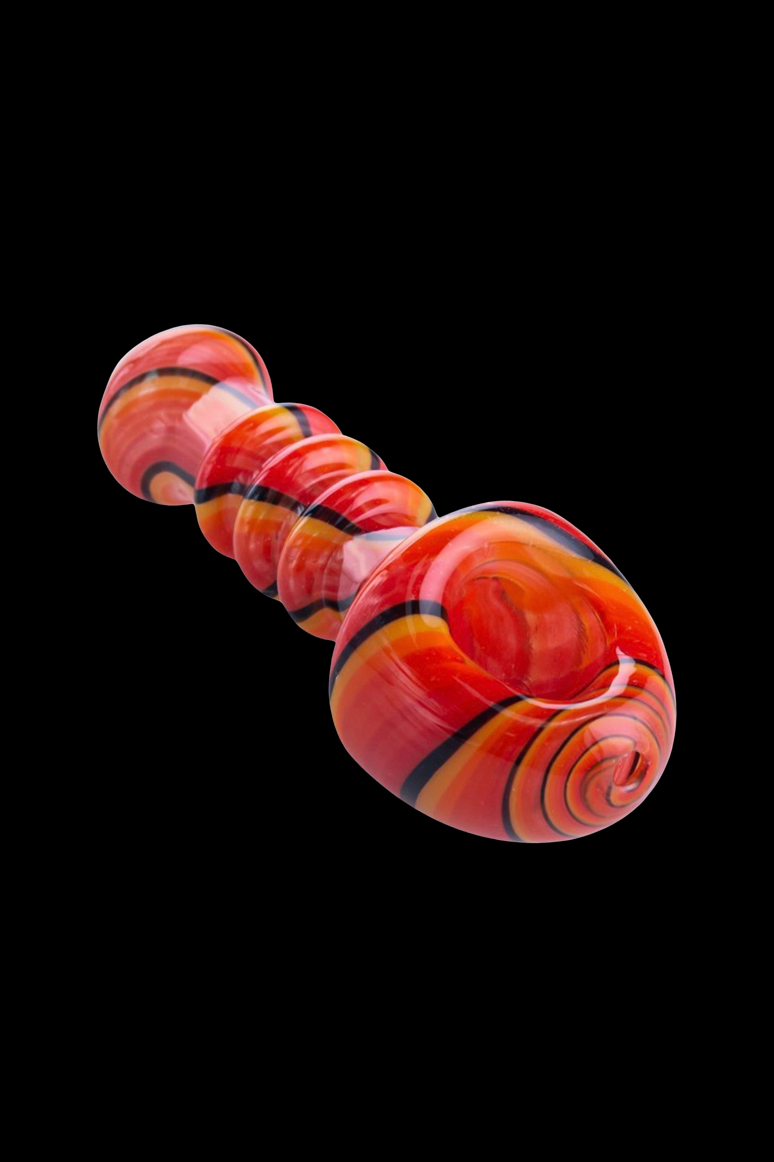 Red and orange swirled glass bubbler pipe against a black background.