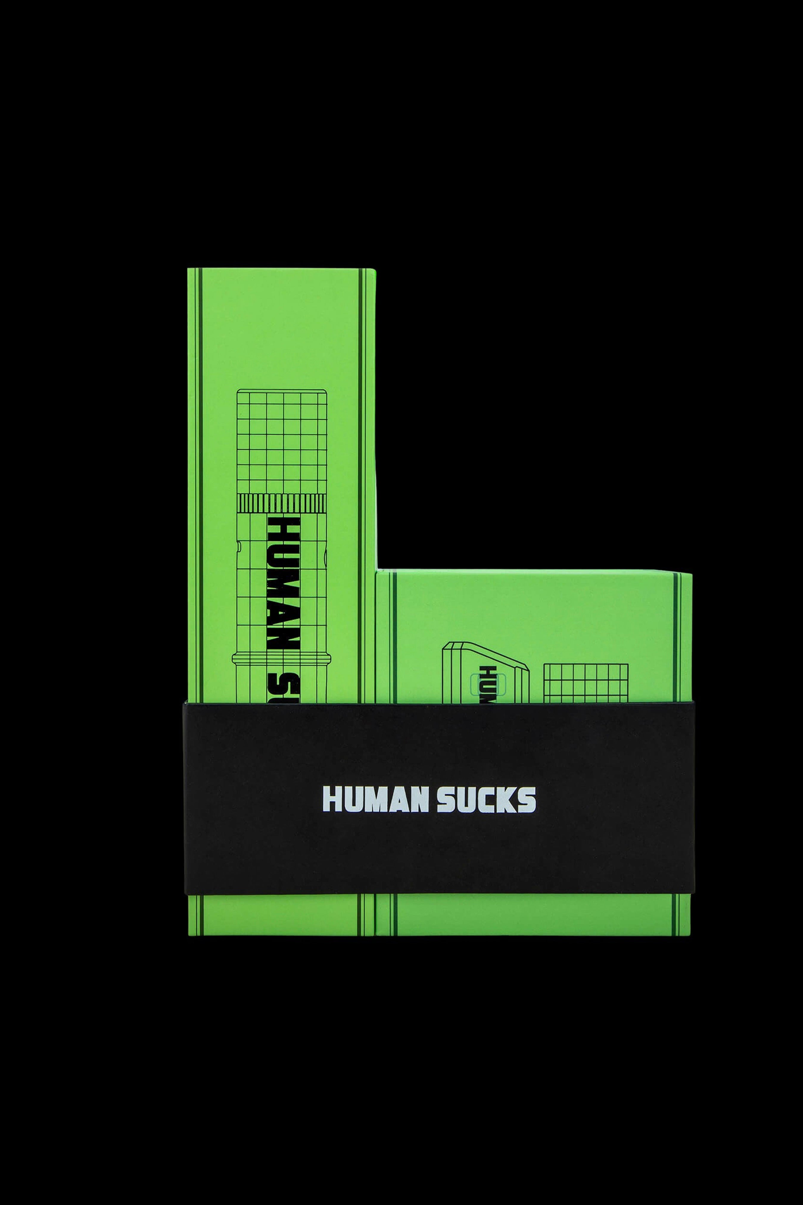 Green glass cannabis water pipe with "HUMAN SUCKS" text.