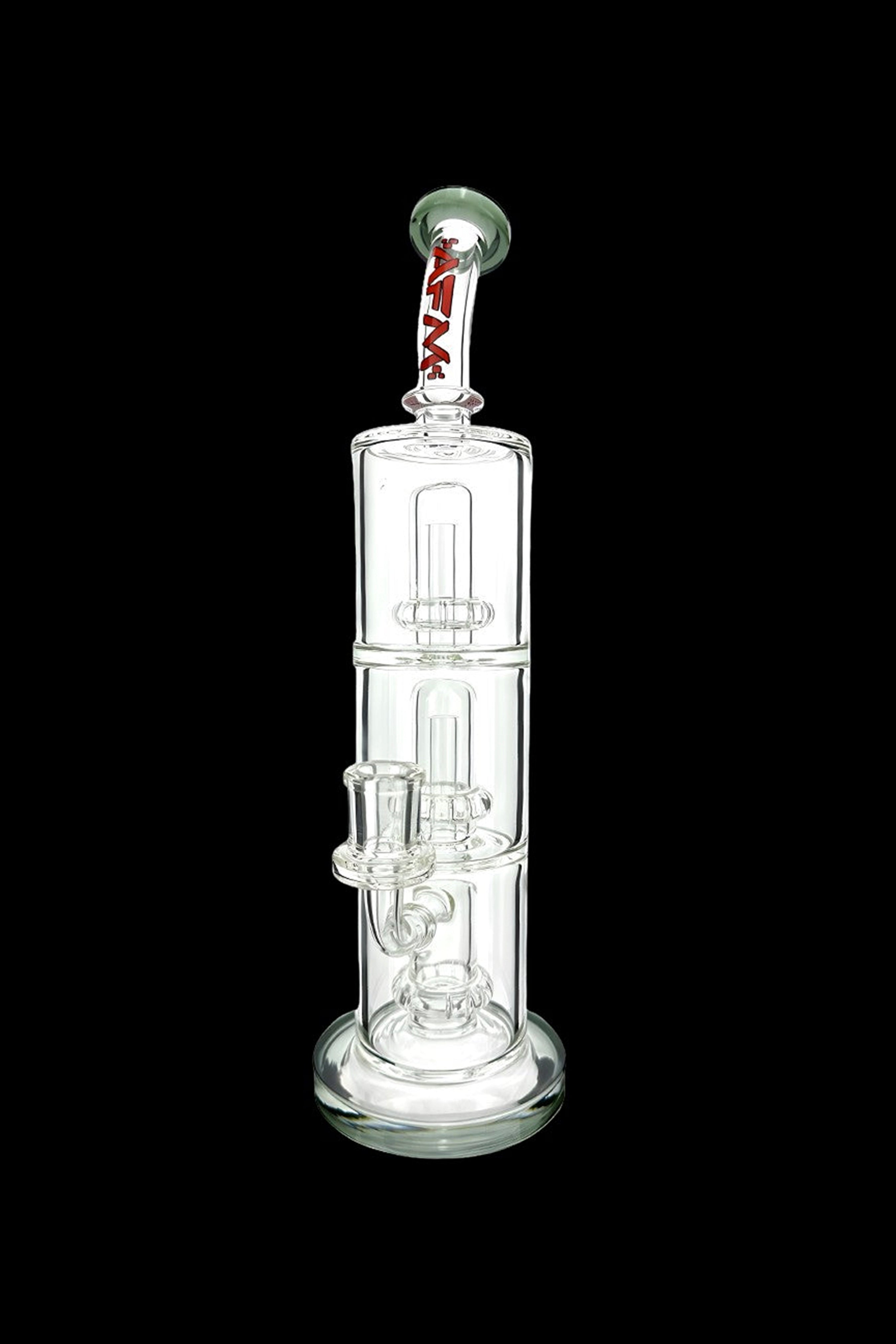 Clear glass water pipe (bong) with multiple chambers and percolators, isolated on a black background.