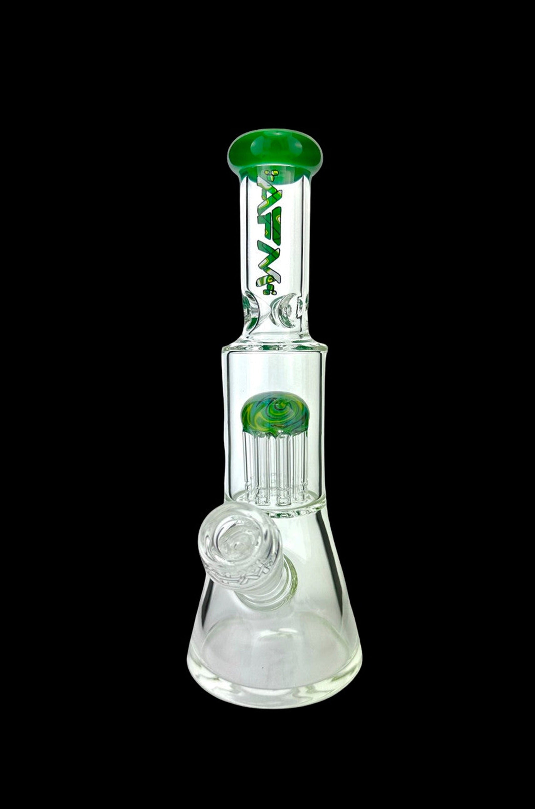 Clear glass water pipe (bong) with green accents and intricate percolators, isolated on a black background.