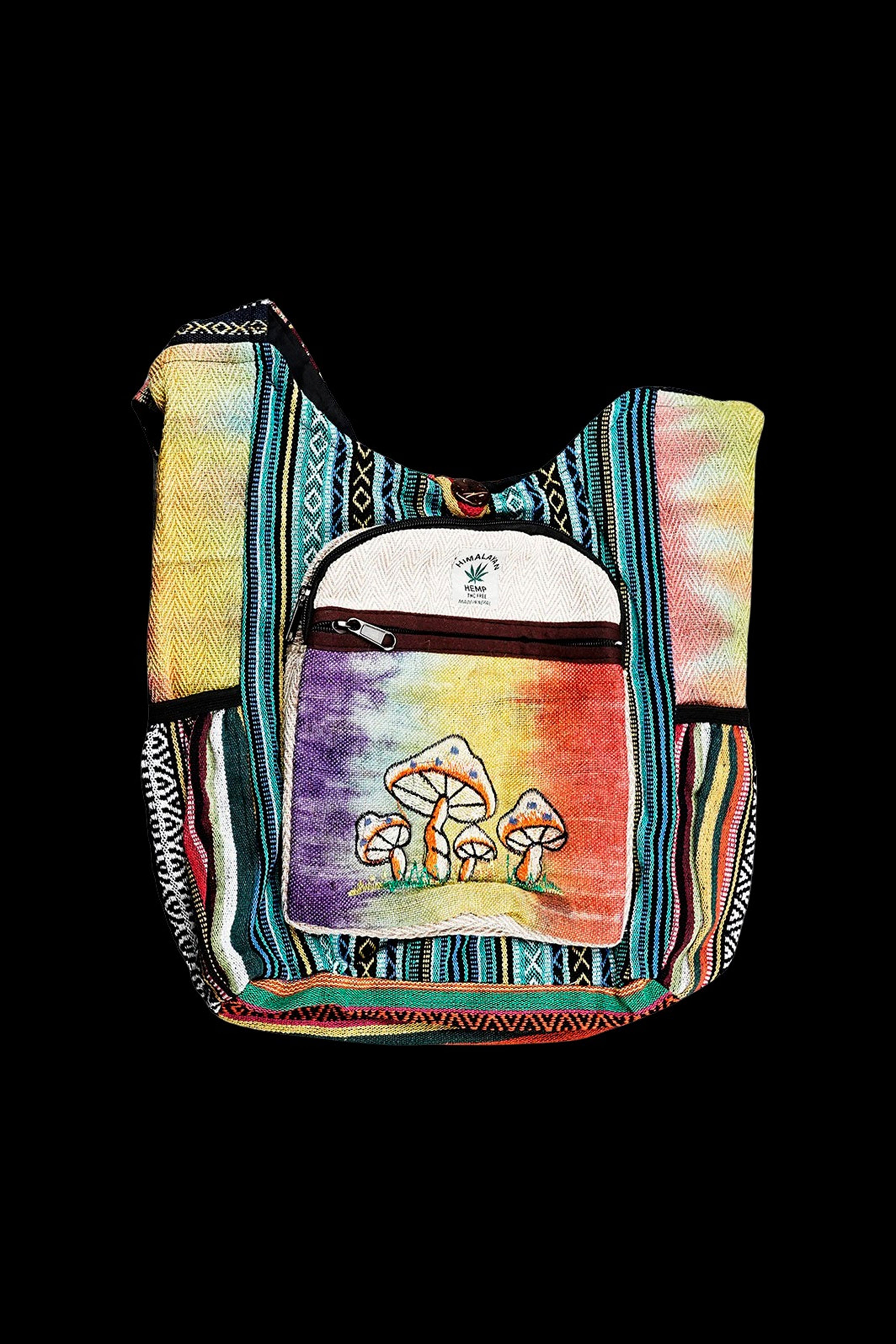 Handwoven shoulder bag with a psychedelic mushroom design, likely for carrying cannabis accessories.