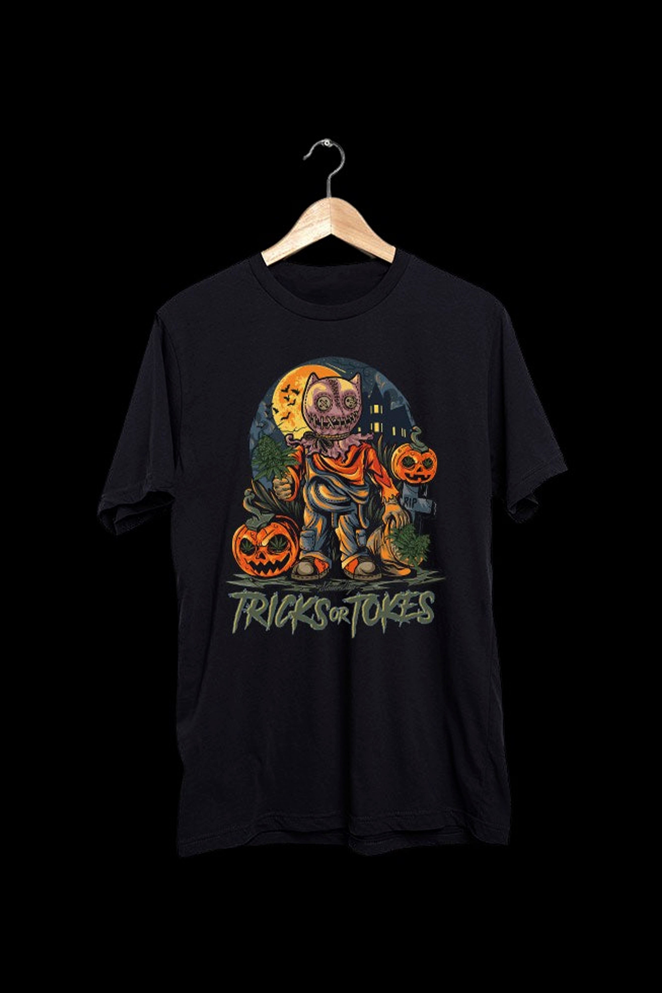 Black t-shirt with a Halloween-themed graphic featuring a jack-o'-lantern character and the text "Tricks or Tokes."