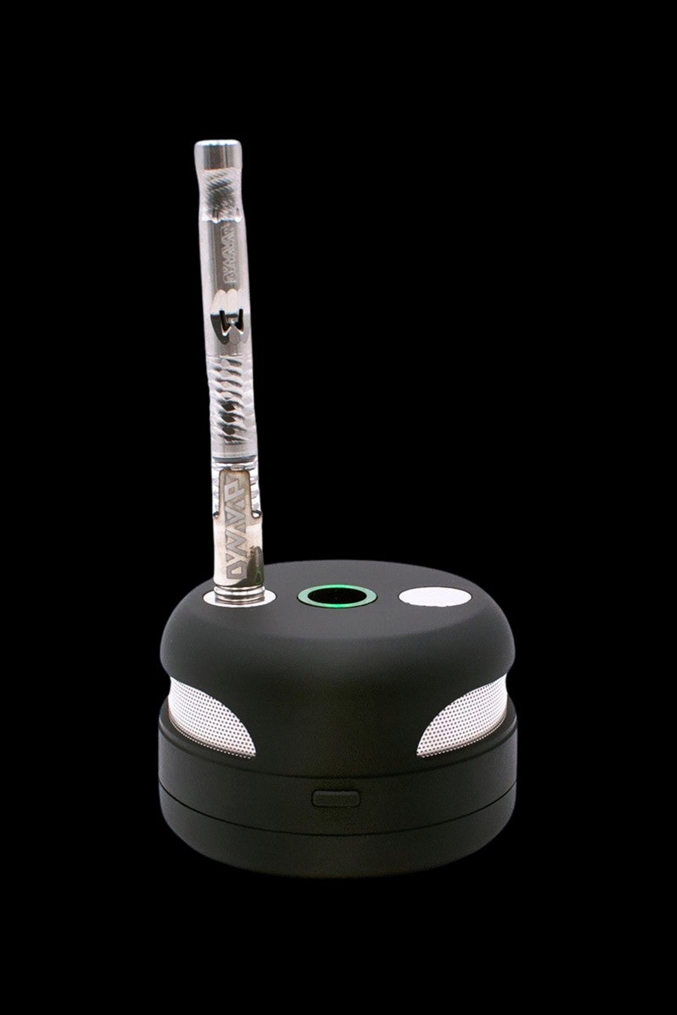 Black cannabis oil vaporizer pen docked on a charging base with indicator lights.