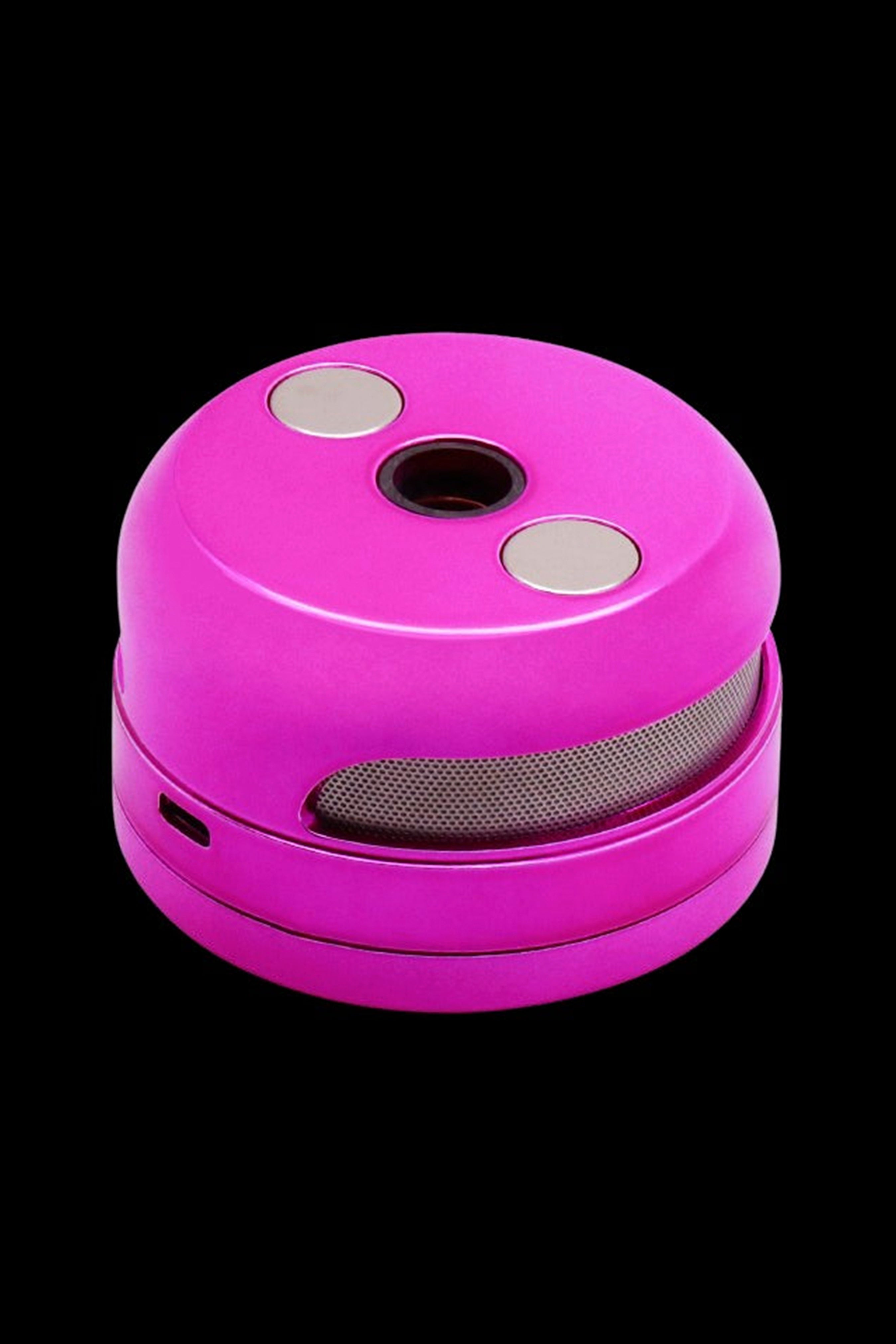 Bright pink cannabis grinder with metal teeth visible through mesh.
