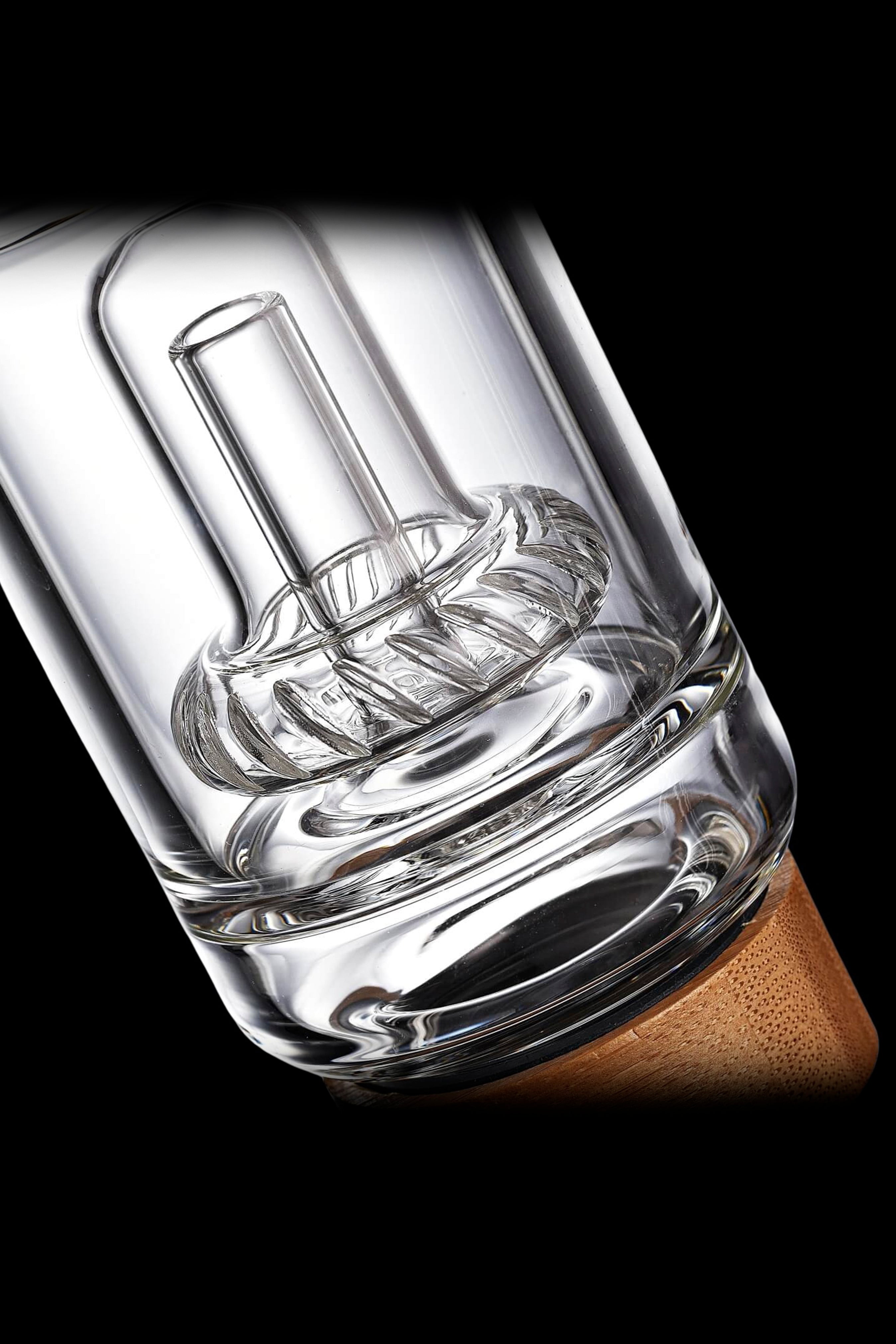 Clear glass bubbler water pipe with intricate percolator design.