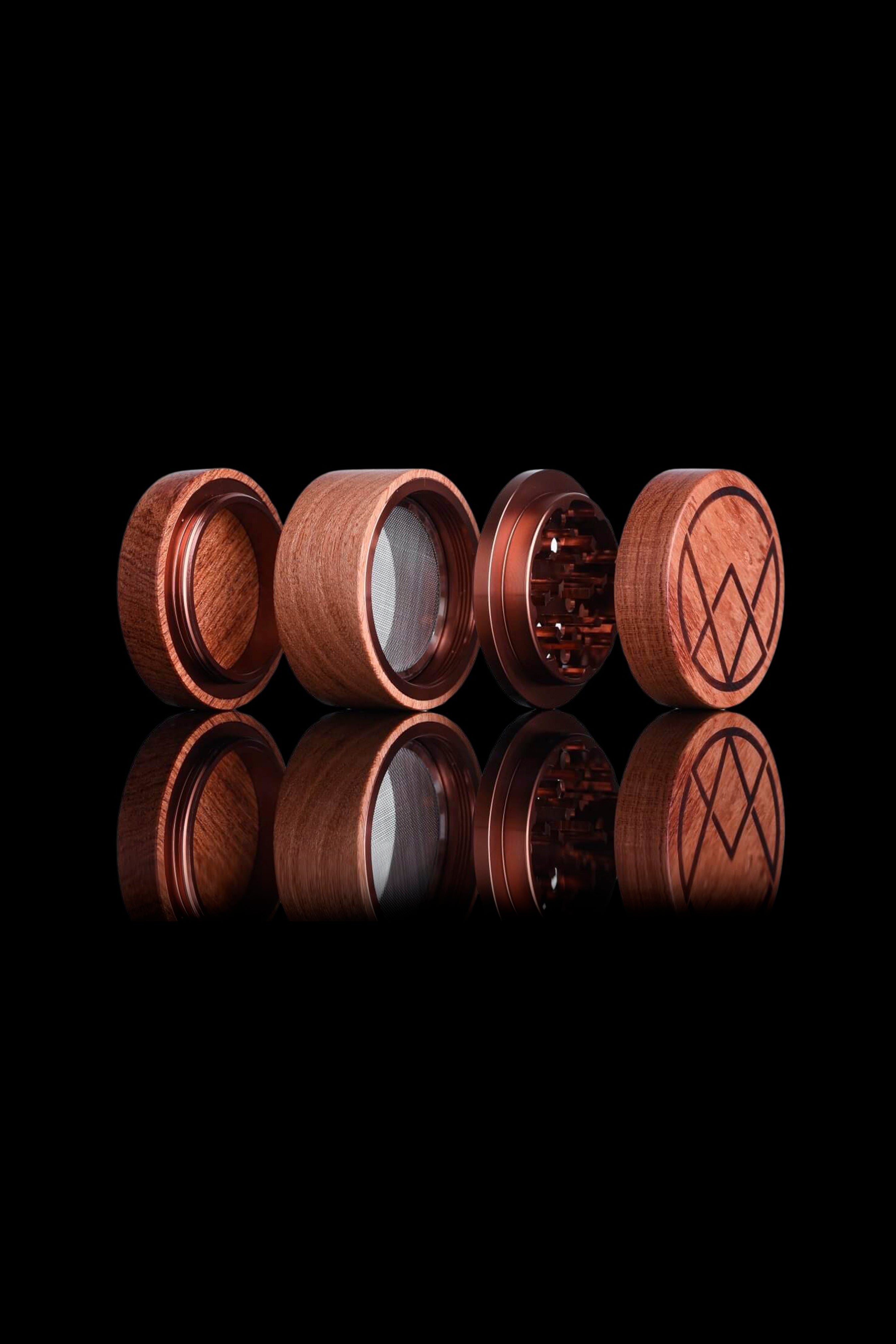 Wooden cannabis grinder components arranged to showcase features and construction.