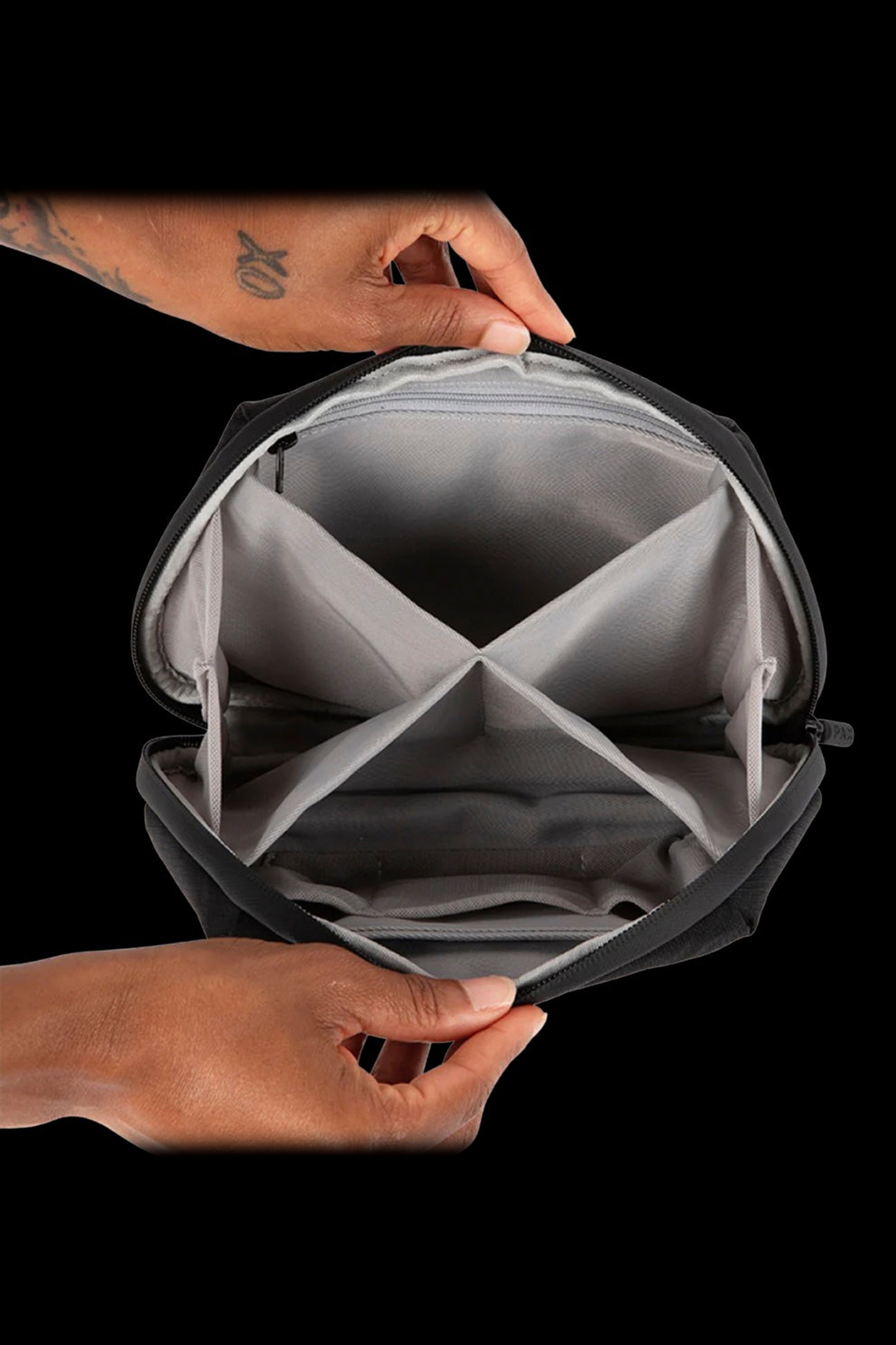 Open cannabis storage case with customizable dividers, viewed from above.