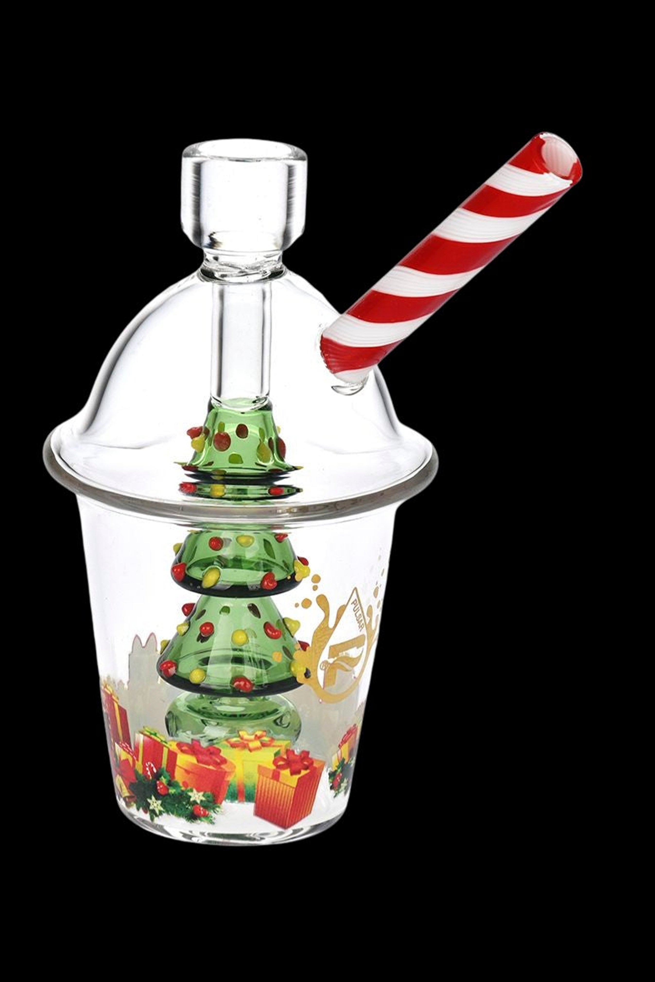 Glass bubbler shaped like a Christmas tree with peppermint straw, against a black background.